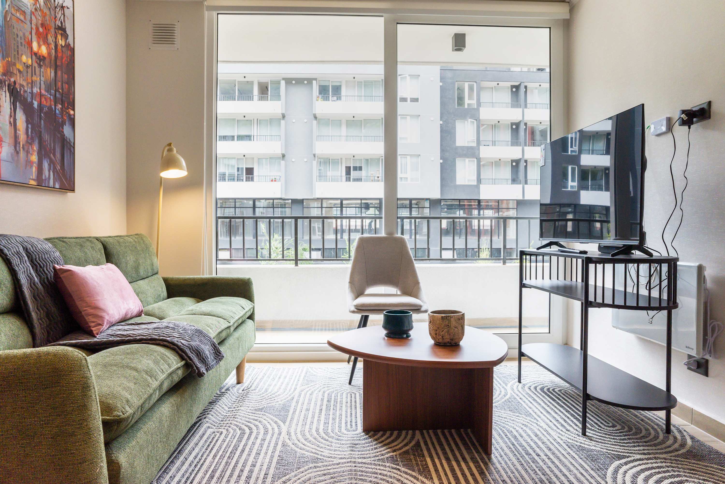 Relax in this cozy living room with a comfy sofa and large window views, perfect for unwinding after a day of exploring.