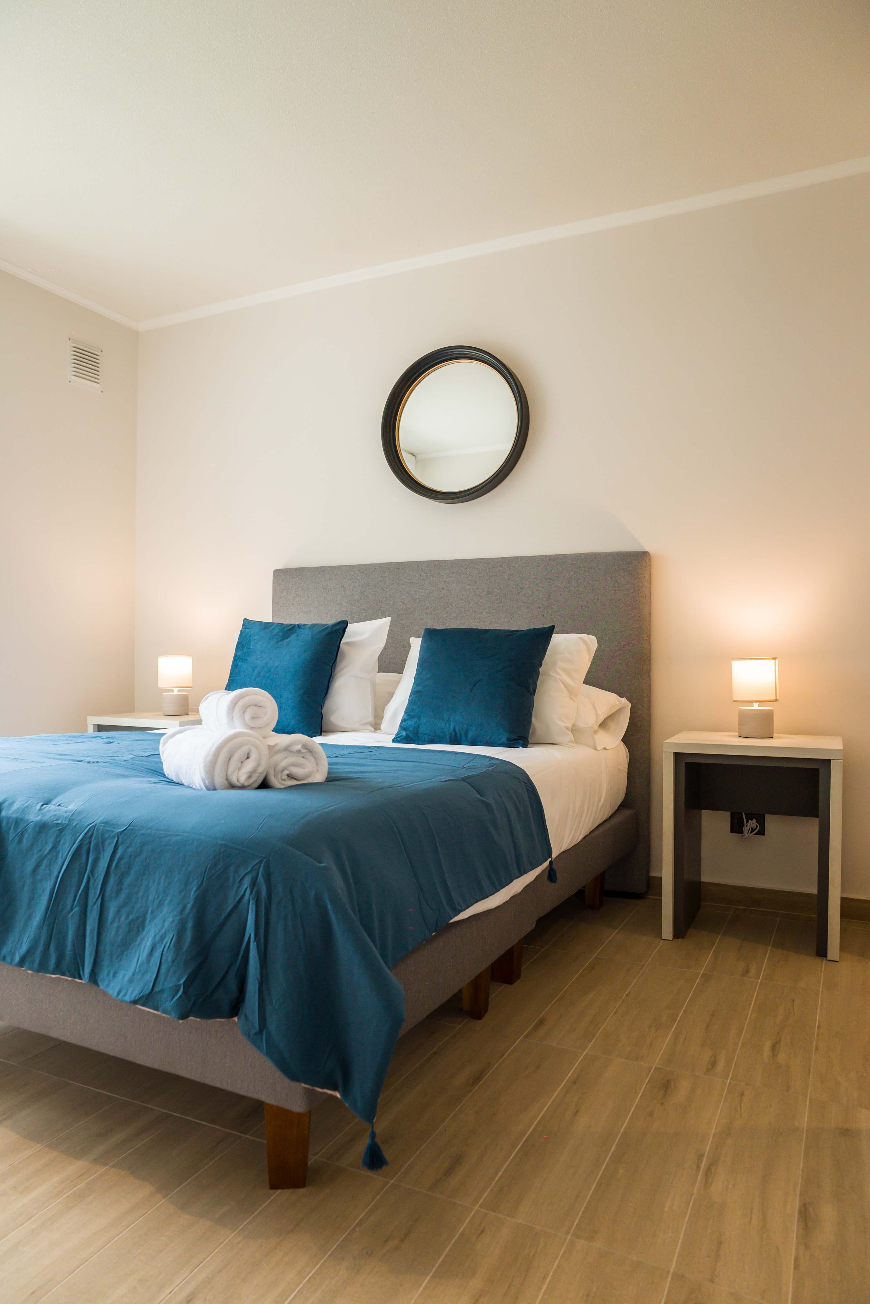 Relax in this cozy bedroom with plush bedding and calming decor, perfect for a restful night's sleep.