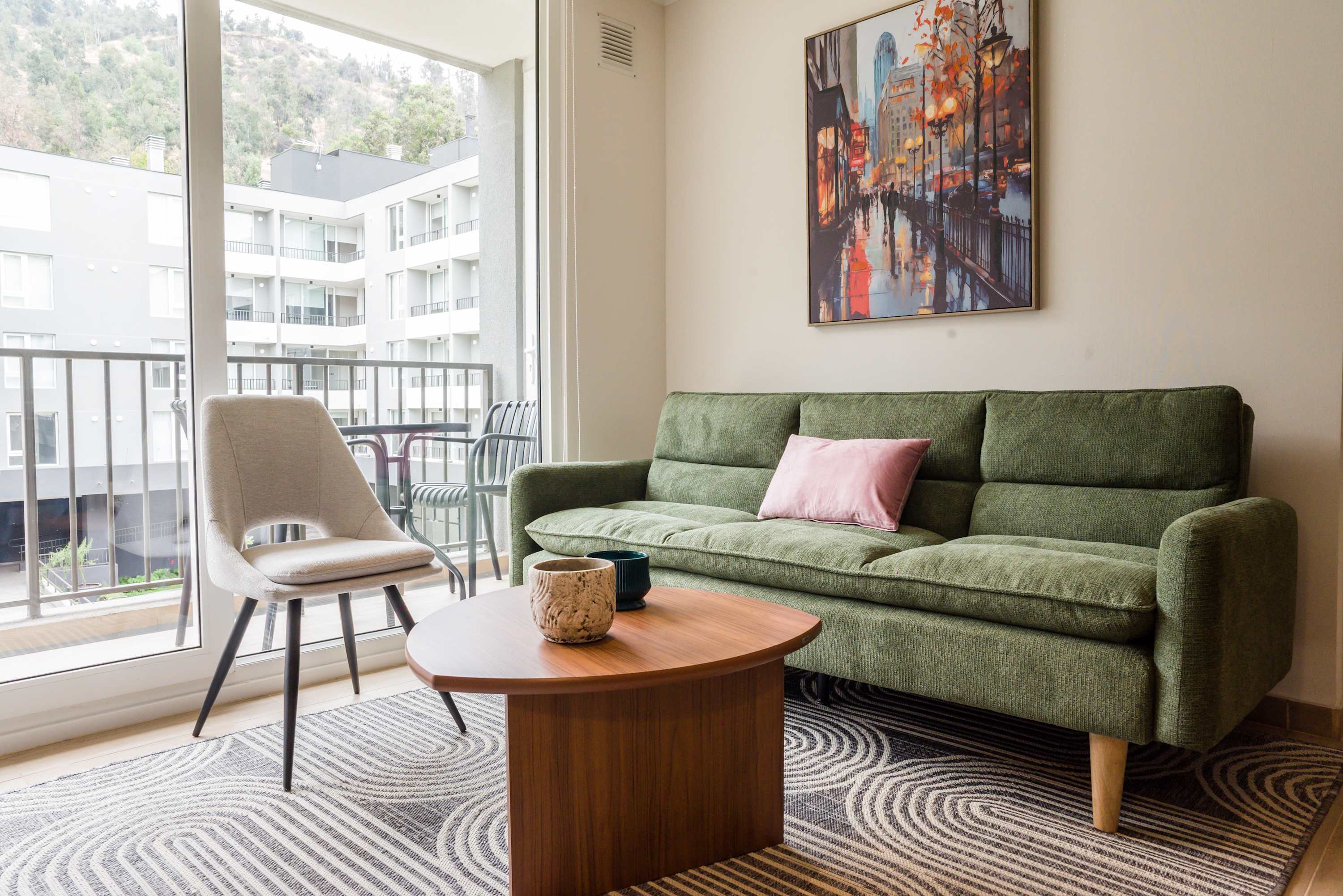 Relax in this stylish living room with a vibrant cityscape view, perfect for unwinding after a day of exploring.