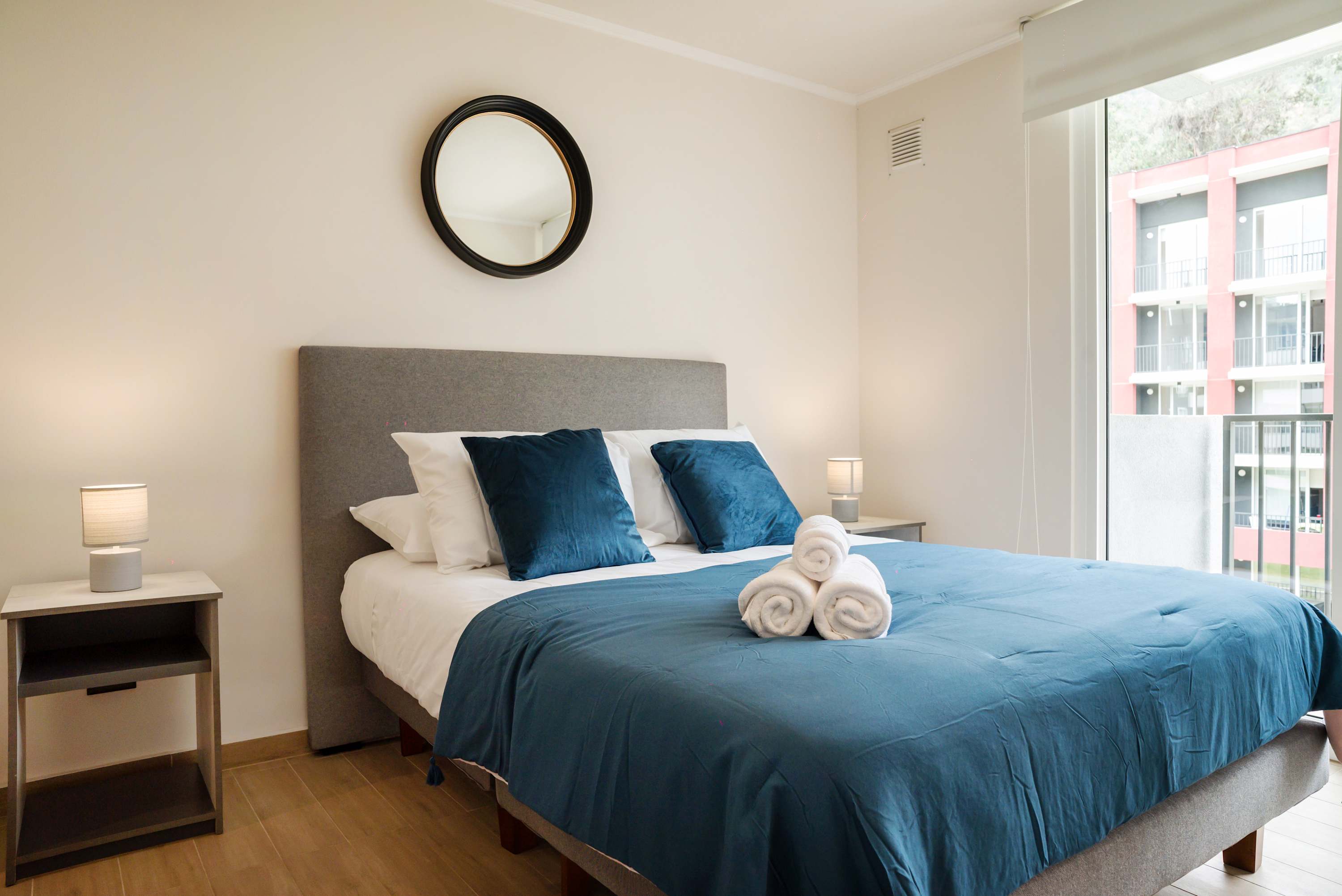 Relax in this cozy bedroom with plush bedding and natural light, perfect for unwinding after a day of exploring.