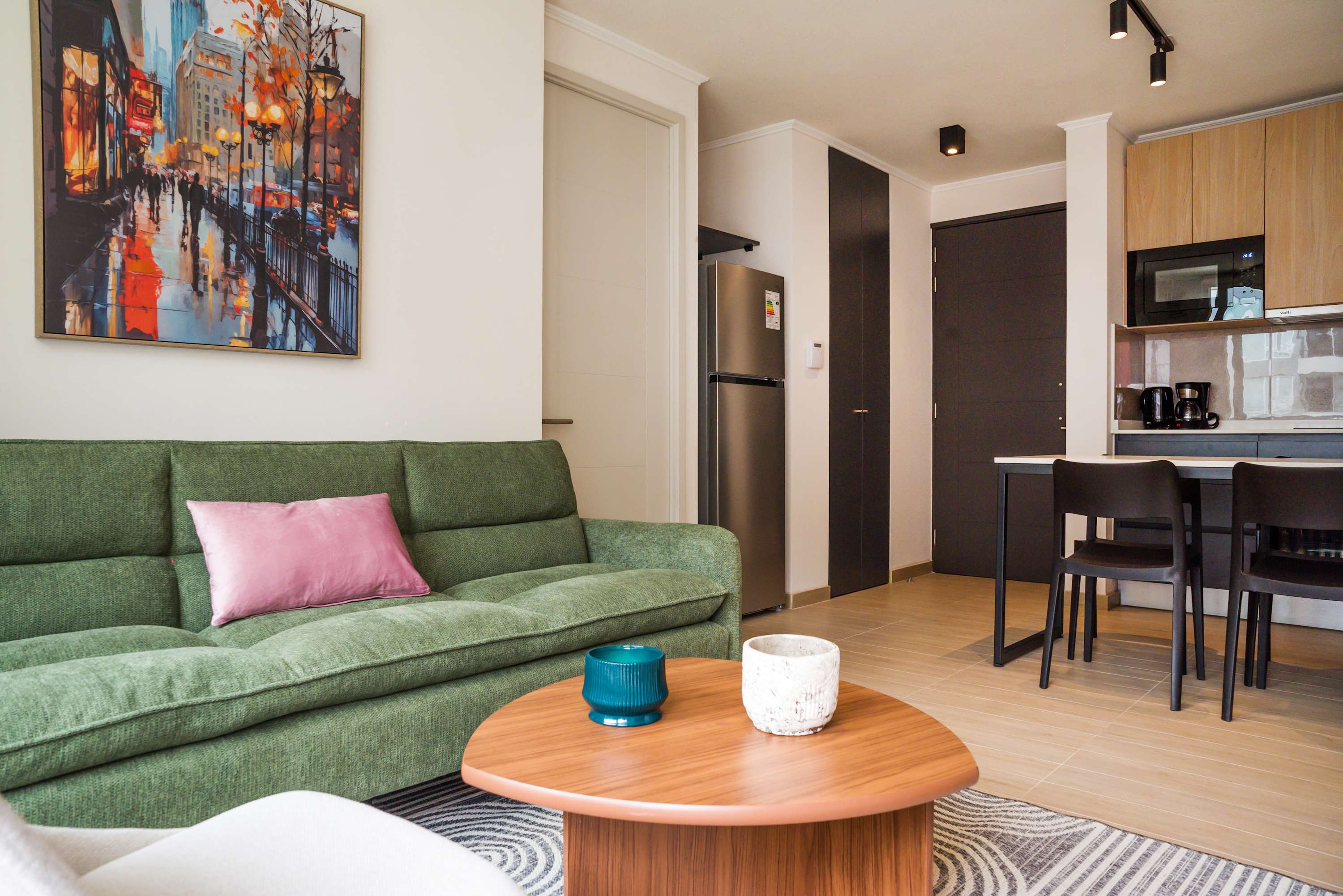 Relax in this stylish living area with a modern kitchen, perfect for unwinding after exploring the city.