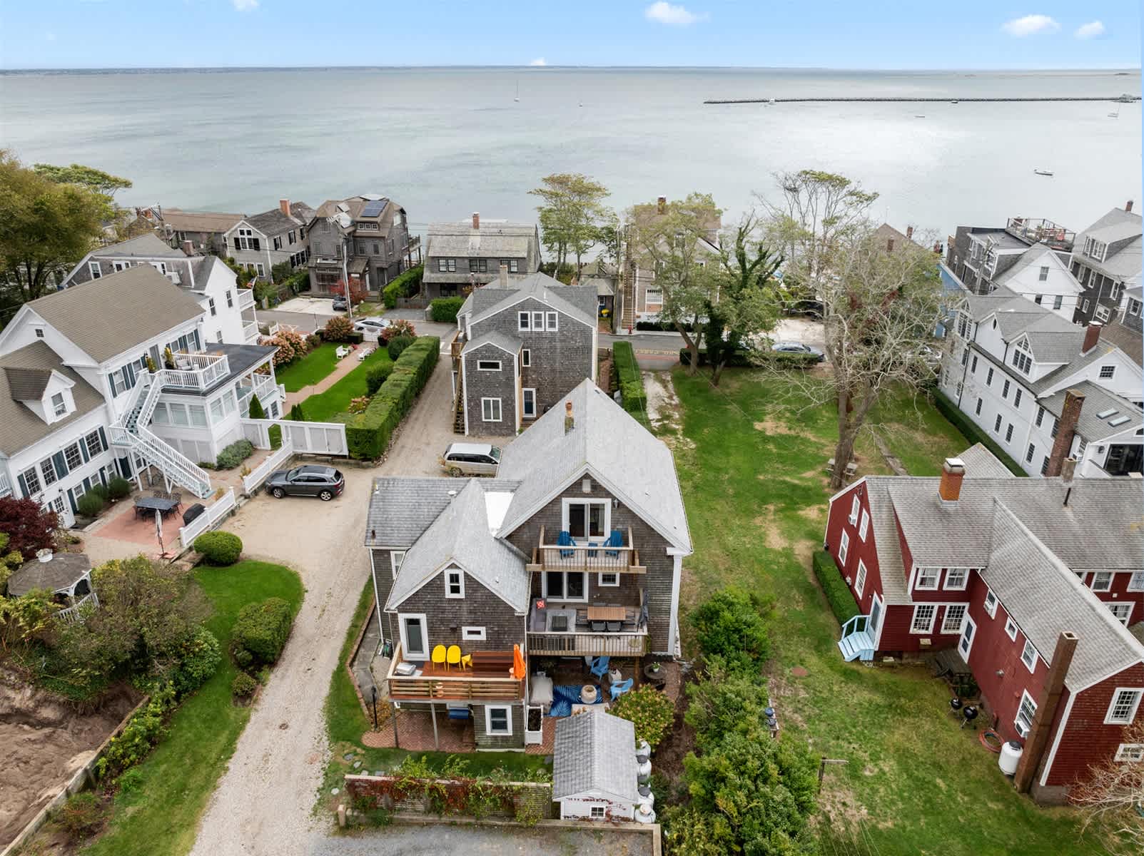 A stunning aerial view showcases this luxury Provincetown retreat overlooking the sparkling waters of Provincetown Harbor.