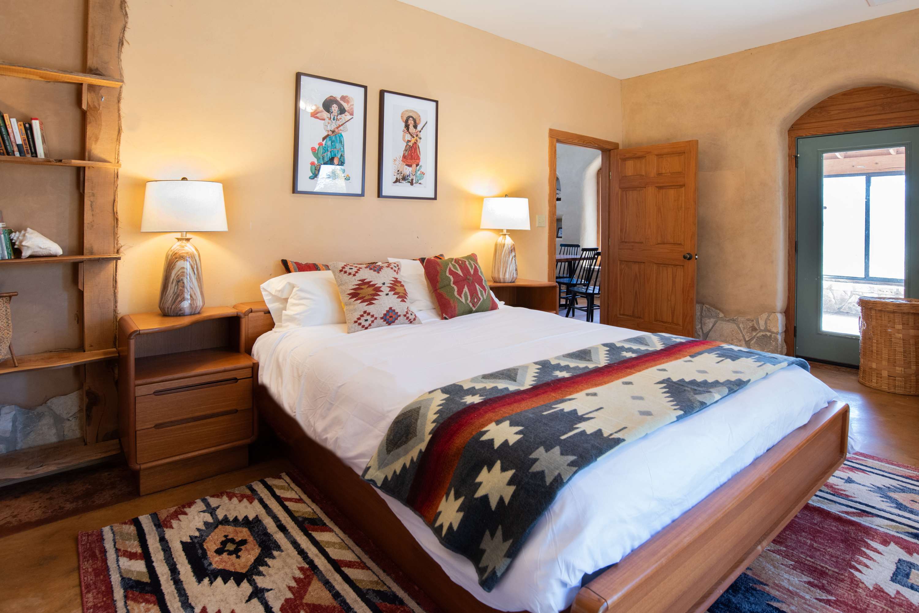 Sunlit queen suite with desk and private patio access