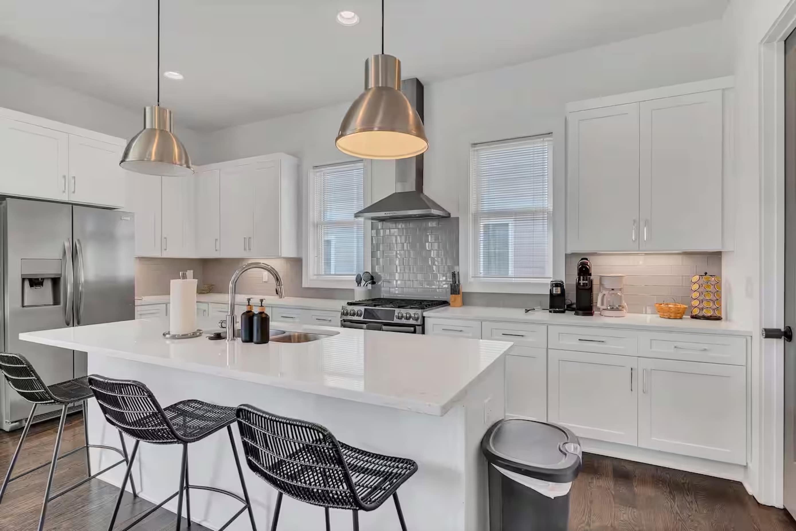 Open-concept kitchen with quartz counters, gas range, and stainless appliances.