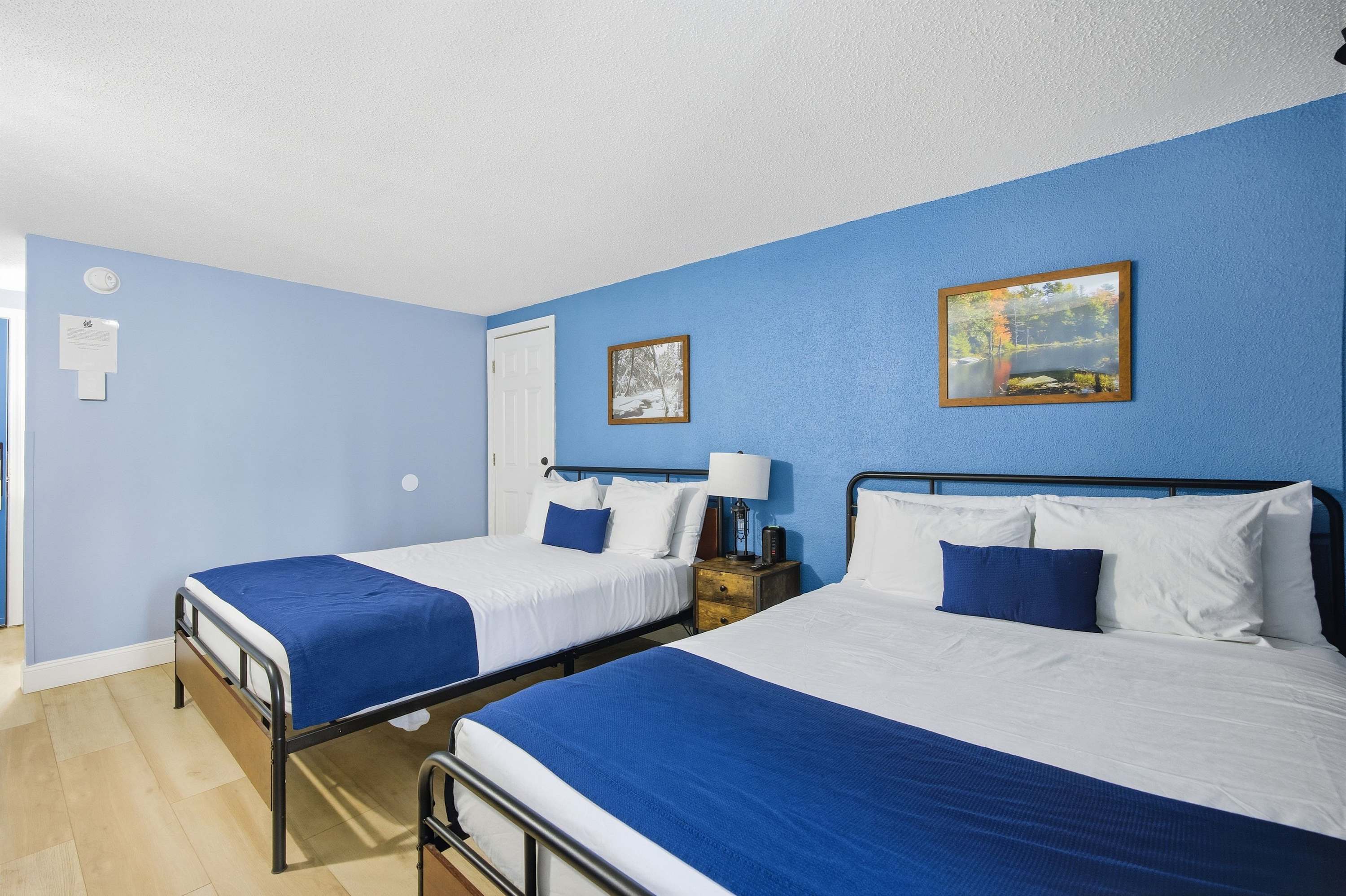 A pair of plush queen beds, a smart TV, & a full bath await in Unit 202​