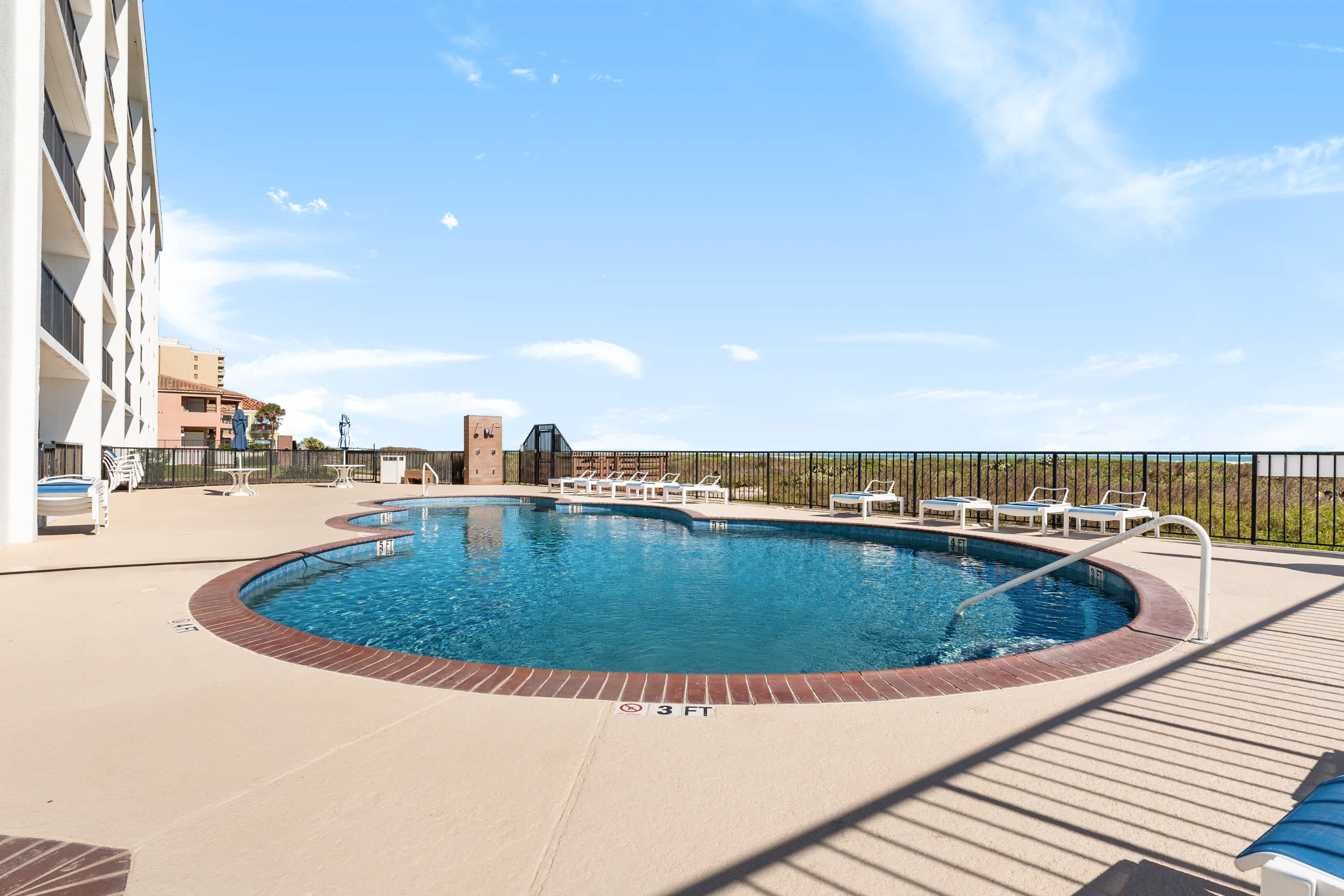 Resort communal pool area + sun loungers