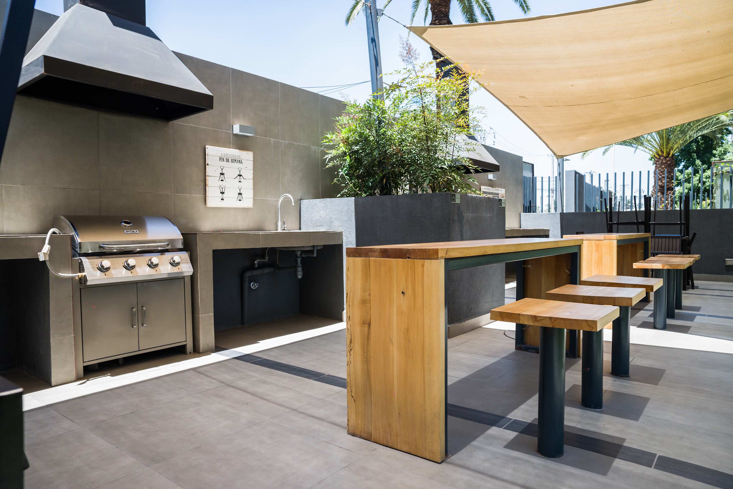 Enjoy outdoor grilling in this stylish shared BBQ area, perfect for gatherings under the sun.