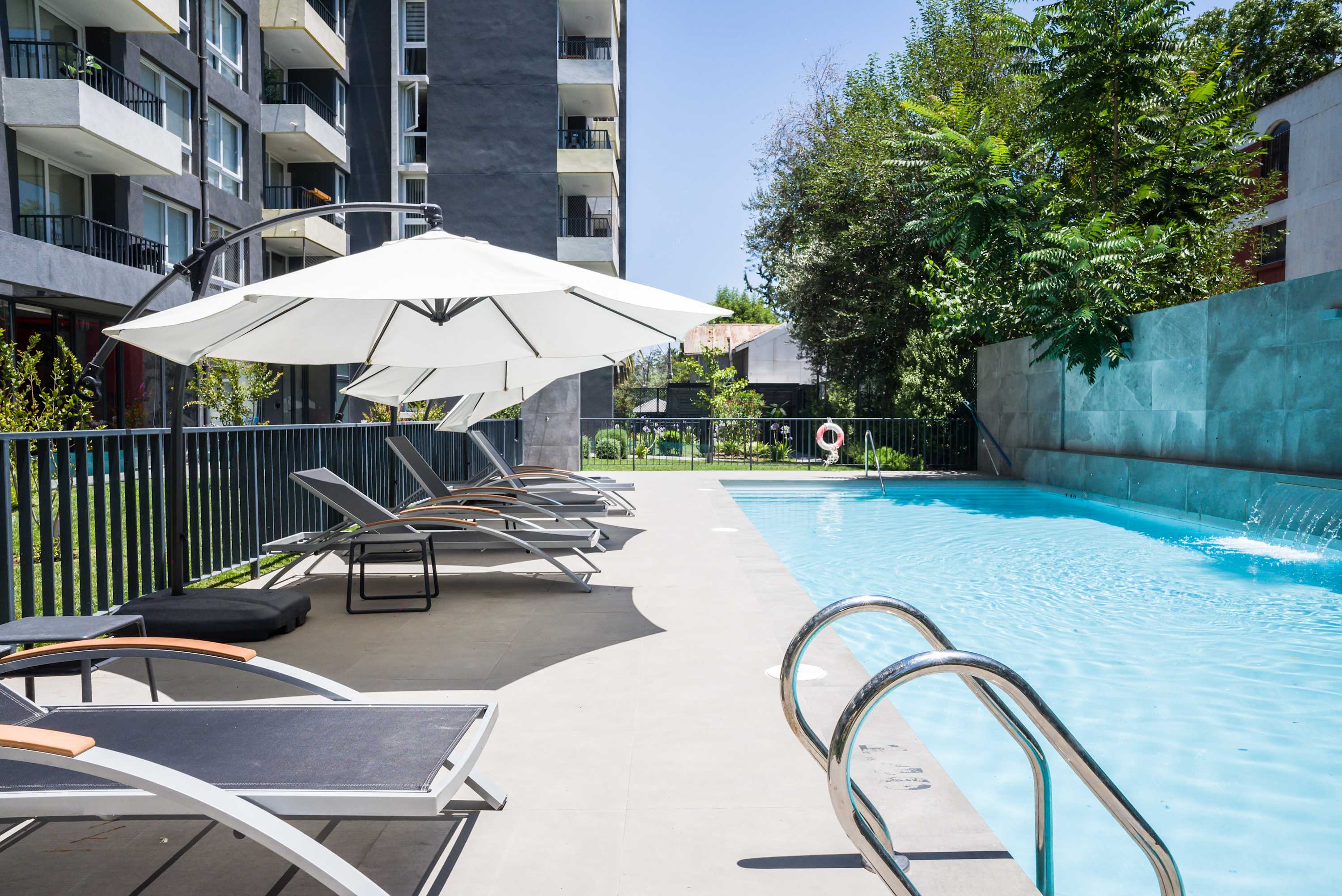 Relax by the pristine poolside with ample lounge chairs and umbrellas, perfect for unwinding under the Chilean sun.