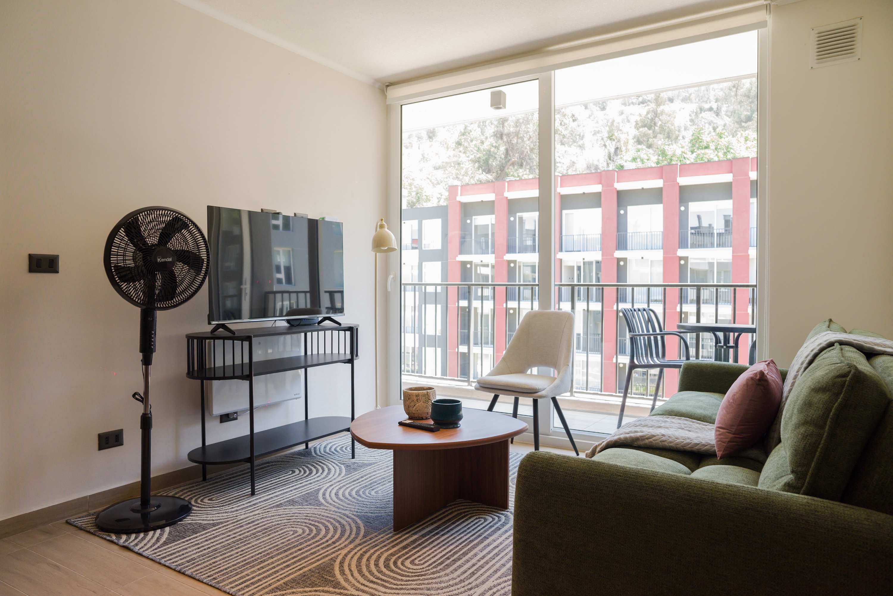 Relax in this bright, modern living area with a view, perfect for unwinding after a day of exploring.