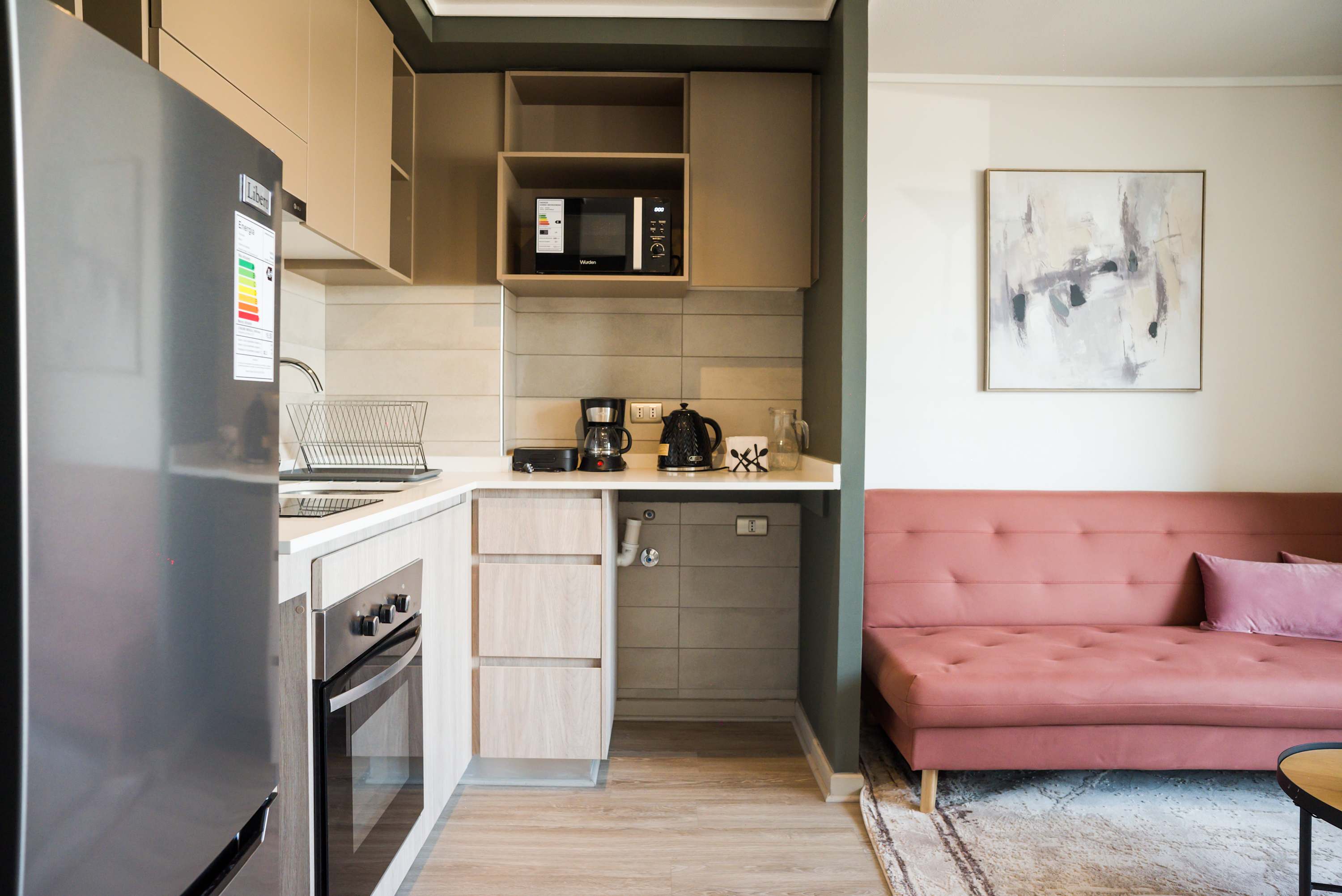 Modern kitchen with sleek appliances and a cozy seating area, perfect for relaxing after a day exploring the city.