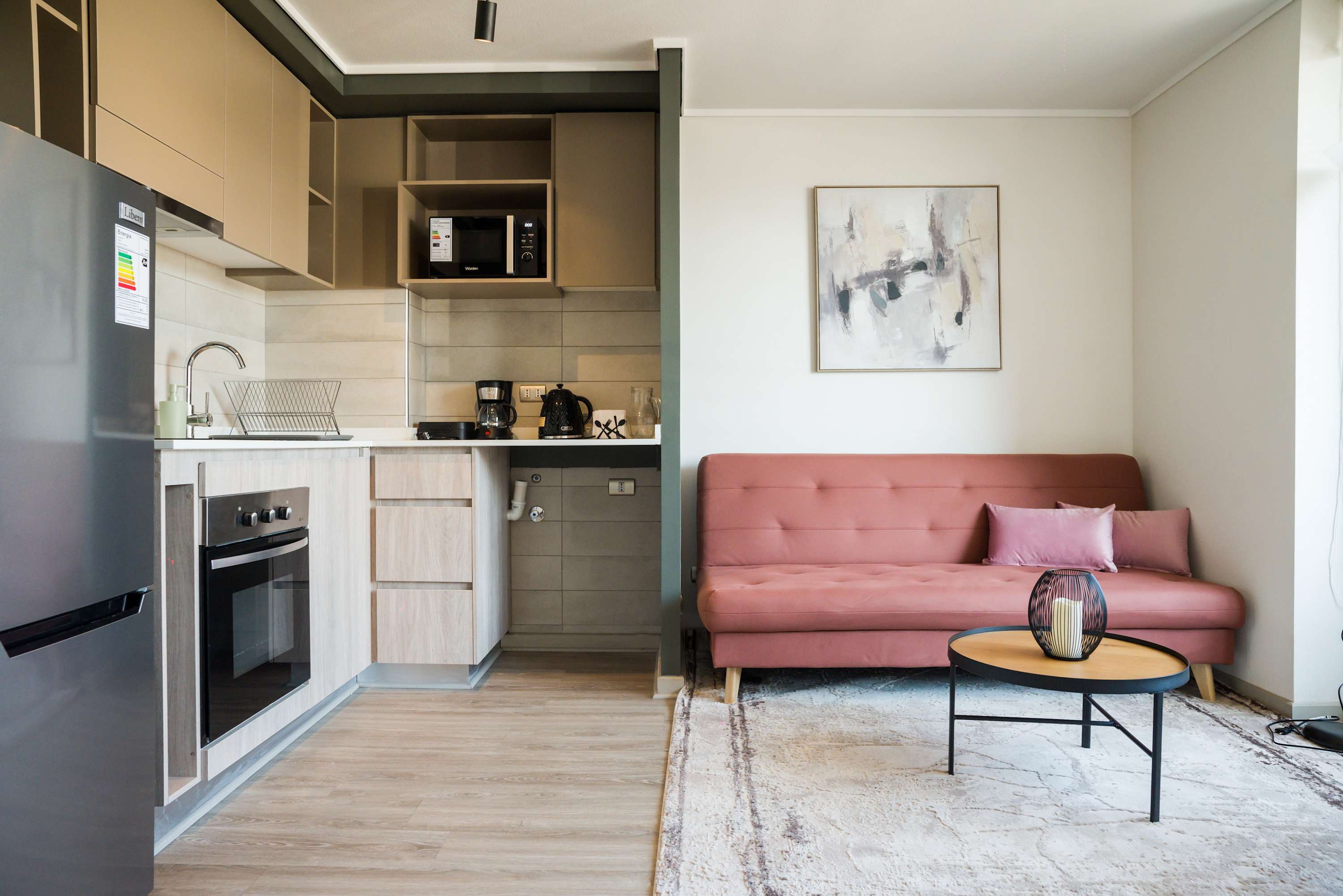 Chic and cozy living area with modern kitchen, perfect for relaxing after exploring the city.