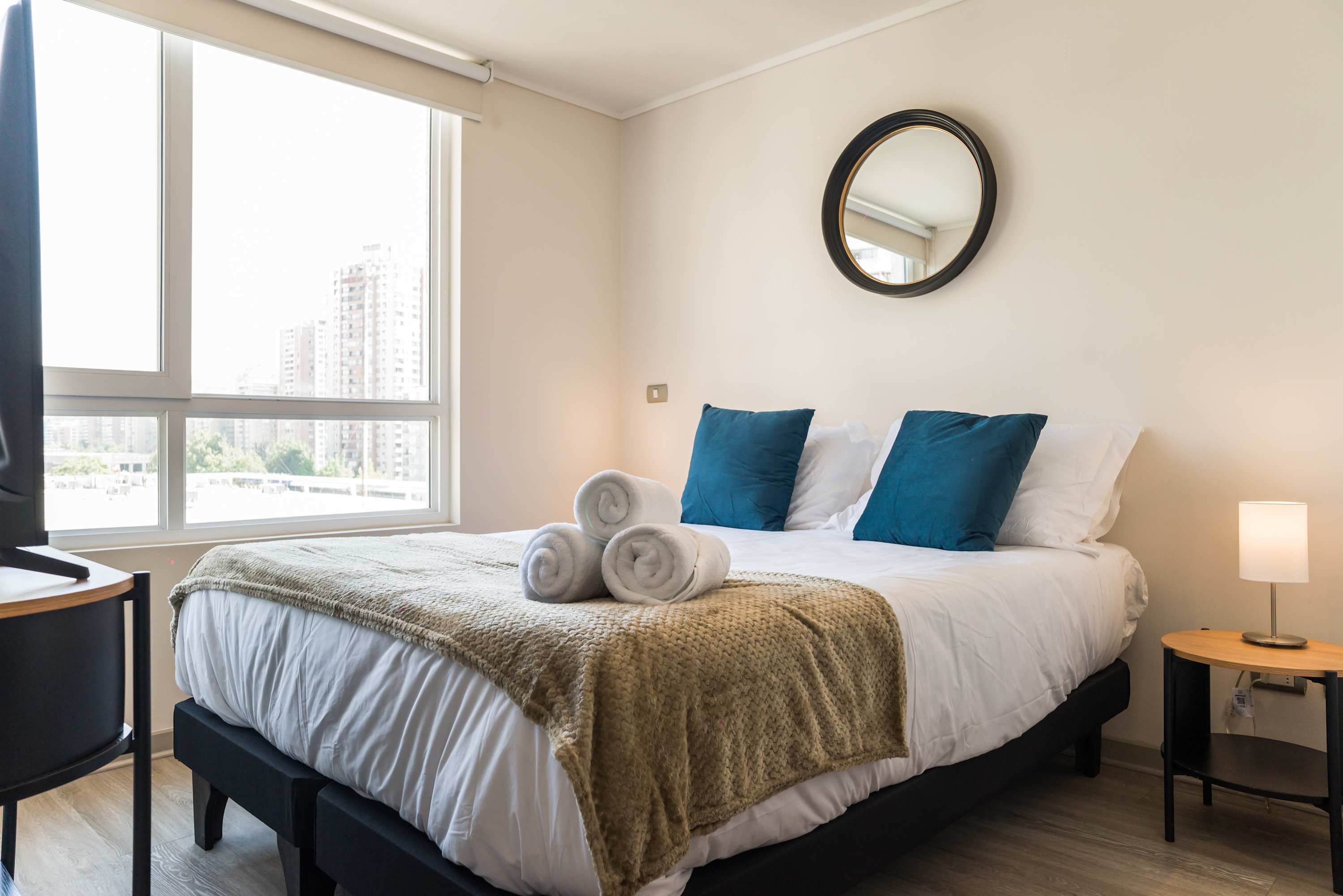 Relax in this bright and cozy bedroom with city views, perfect for unwinding after a day of exploring.