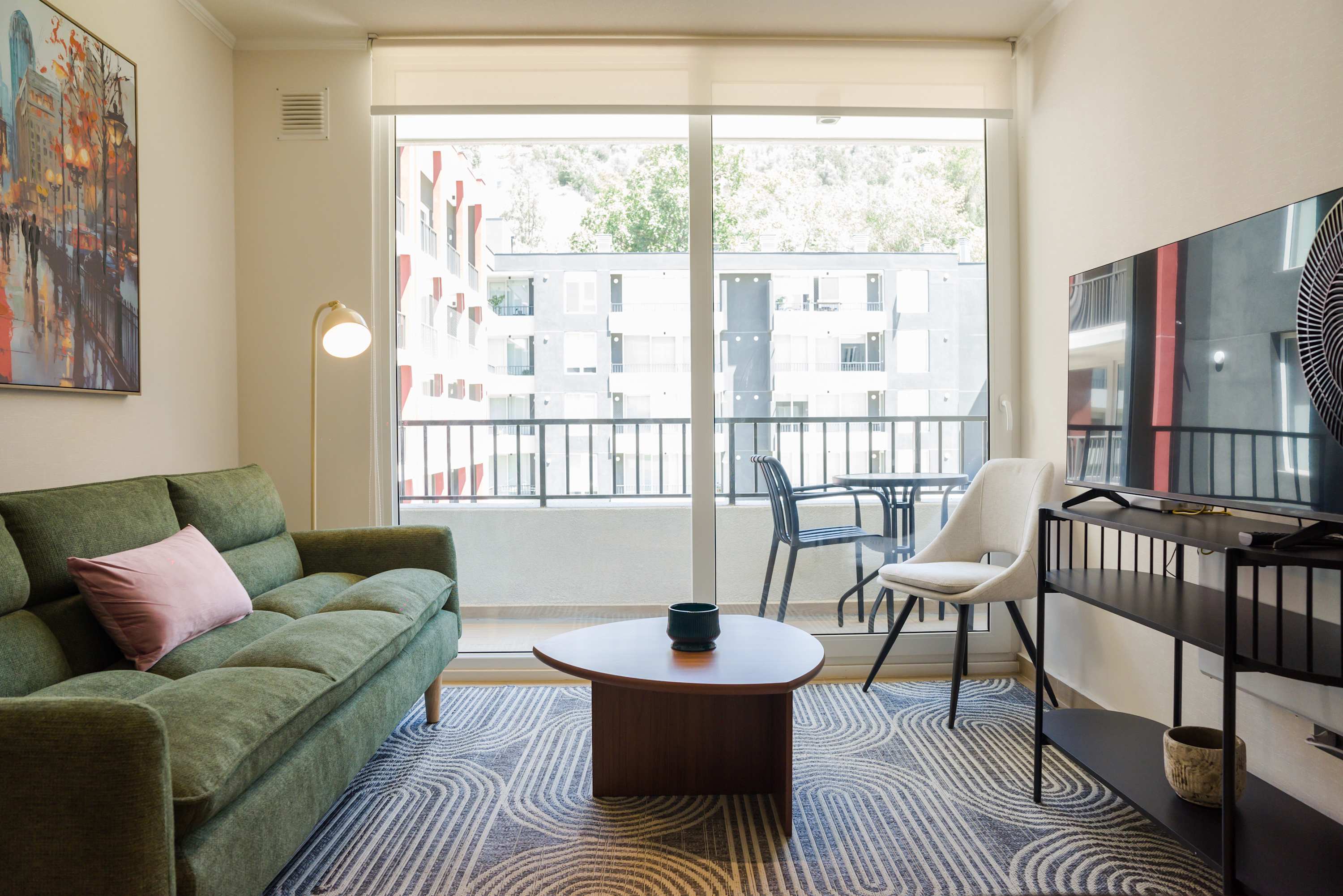 Bright and modern living room with balcony access, perfect for relaxation and enjoying the view.