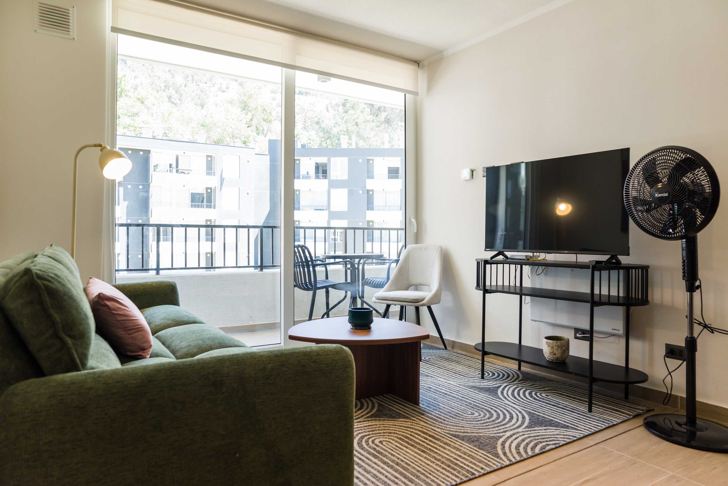 Relax in this bright living room with a balcony view, perfect for unwinding after a day of exploring.