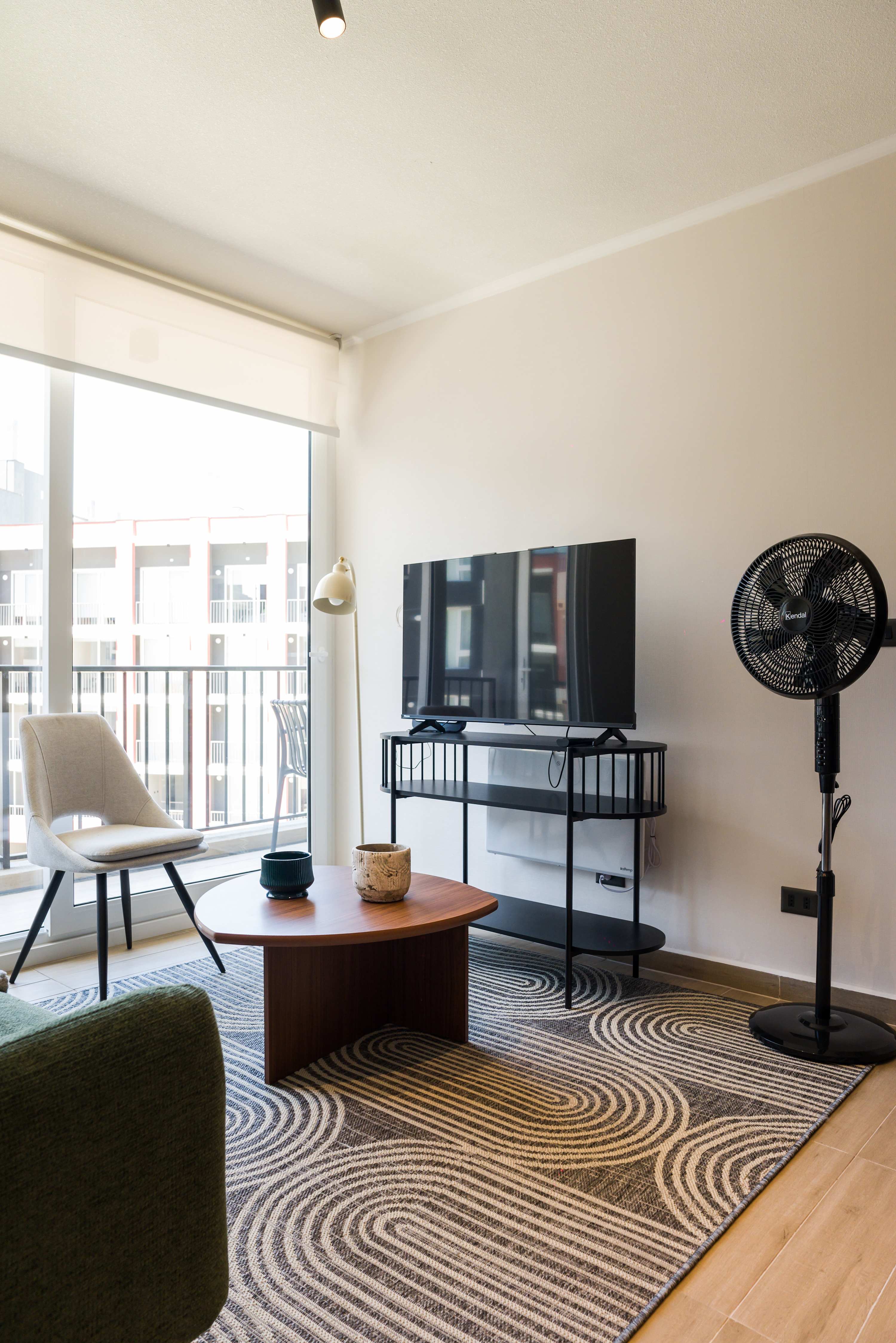 Bright and modern living area with a large window and stylish decor, perfect for relaxation.