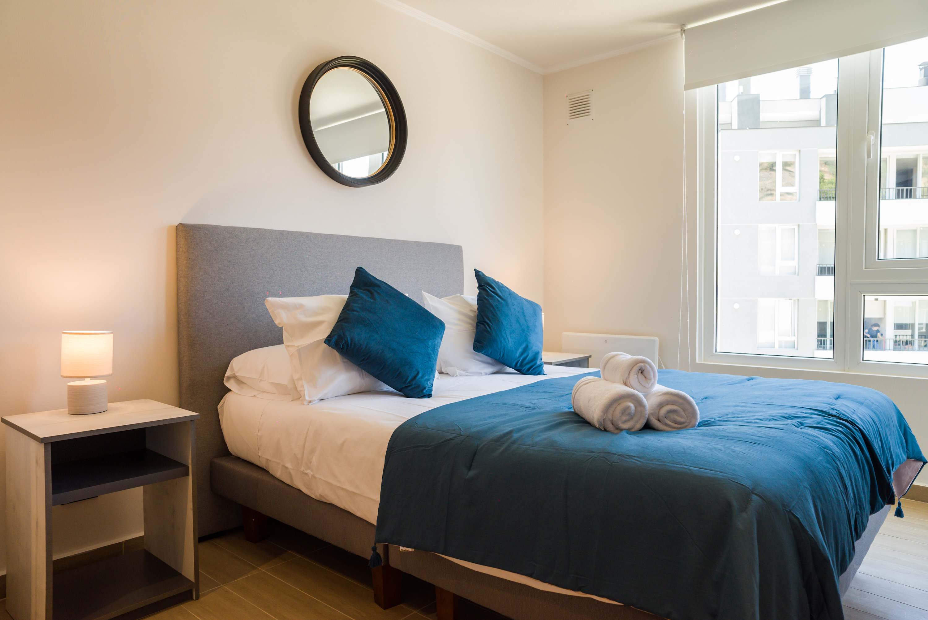 Relax in this cozy bedroom with a plush bed and natural light, perfect for unwinding after a day of exploring.