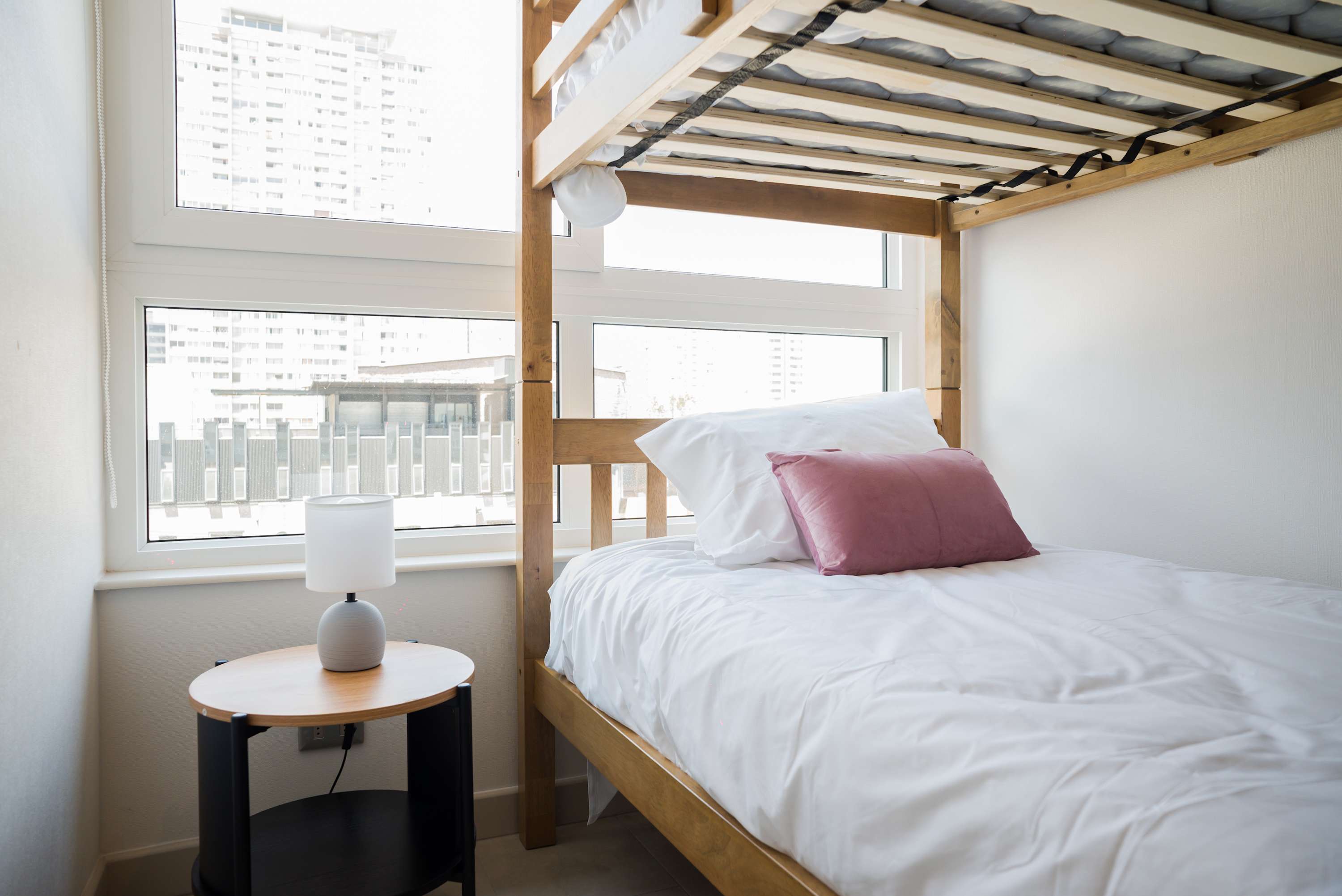 Bright and cozy bedroom with a city view, perfect for a restful stay.