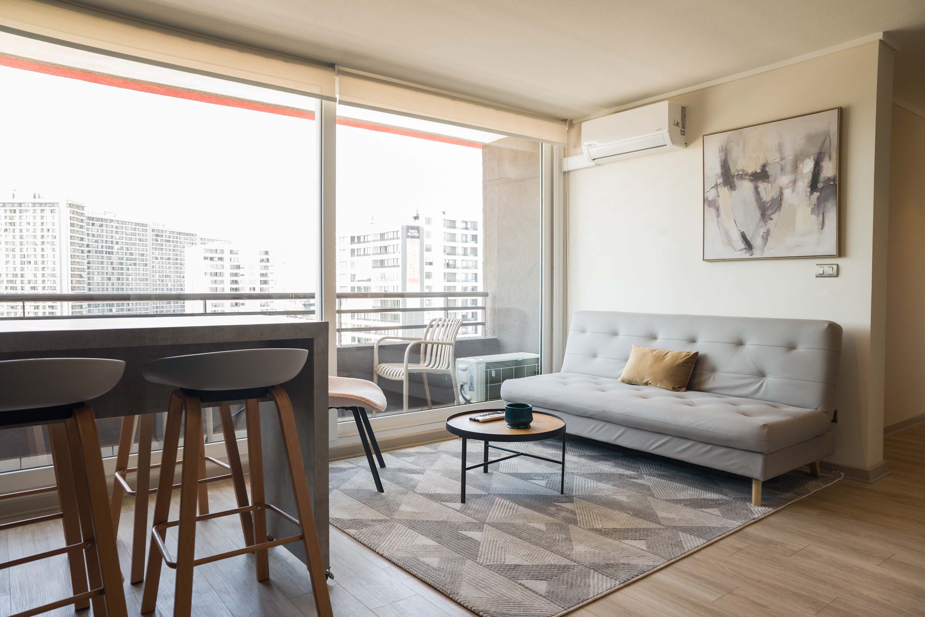 Bright and modern living space with city views, perfect for relaxation and comfort.