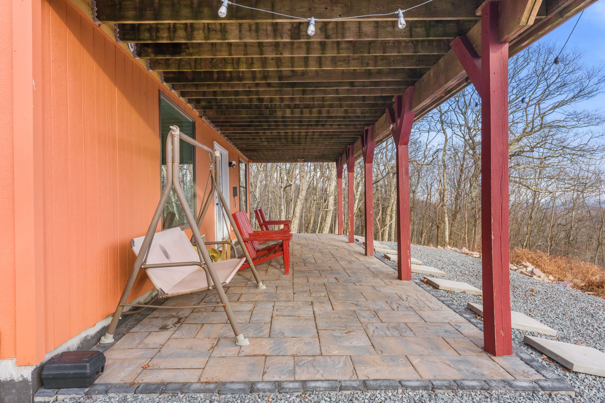 Step onto the covered porch and take in the serene wooded surroundings. The perfect spot to enjoy your morning coffee or evening relaxation.