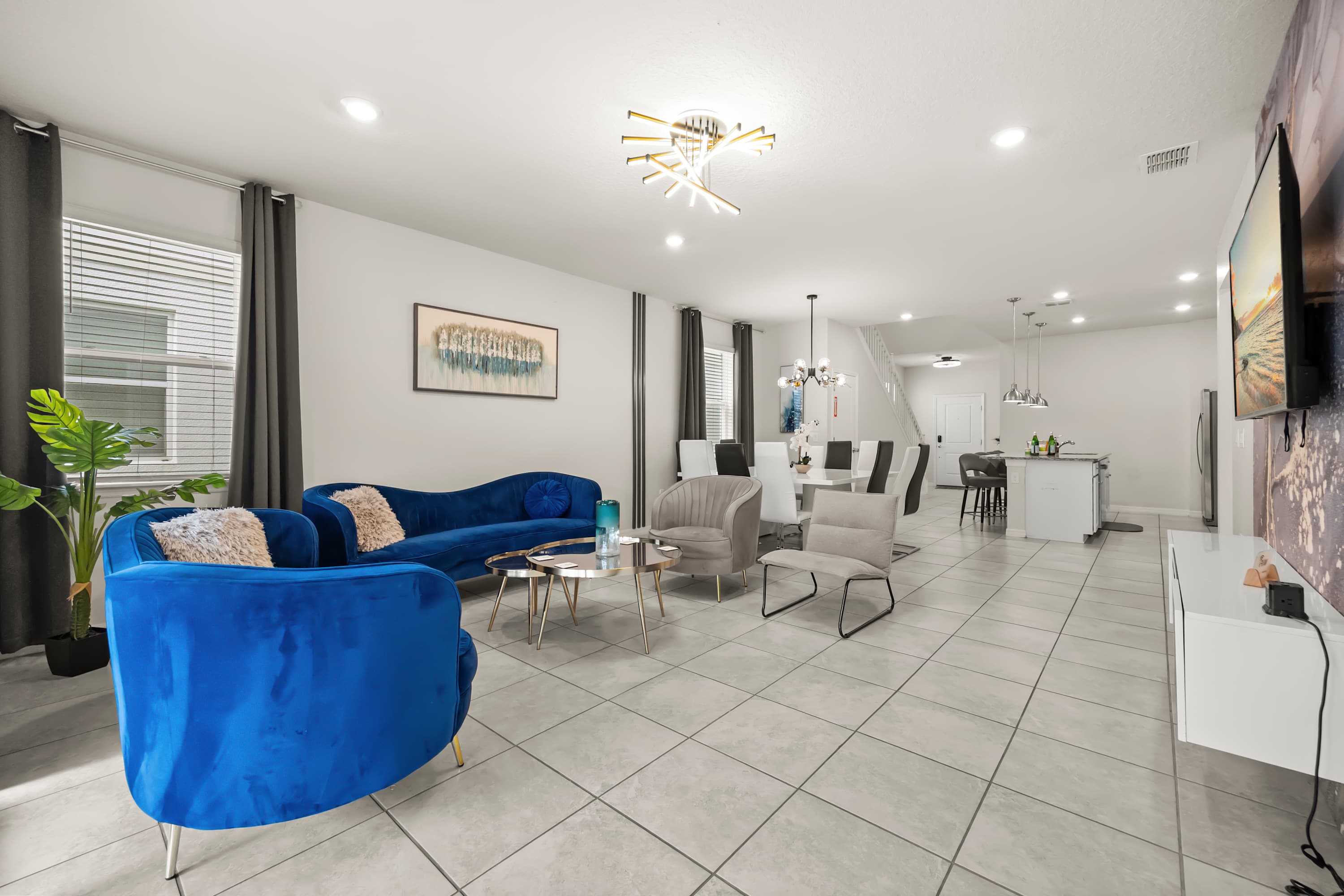 Gorgeous and spacious open concept living area with ample seating space and a smart TV