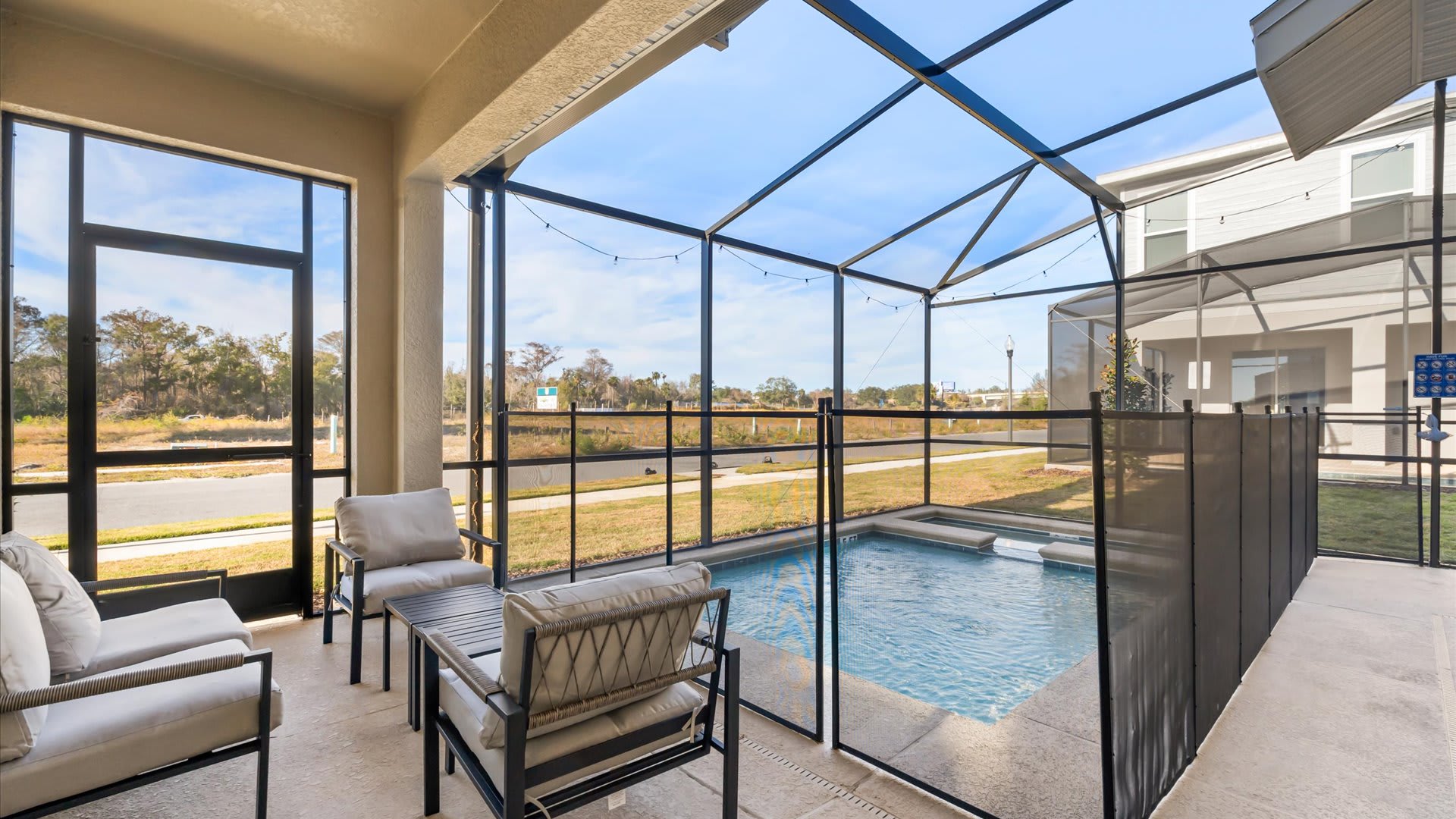 Covered patio with pool views – Outdoor seating for coffee or cocktails