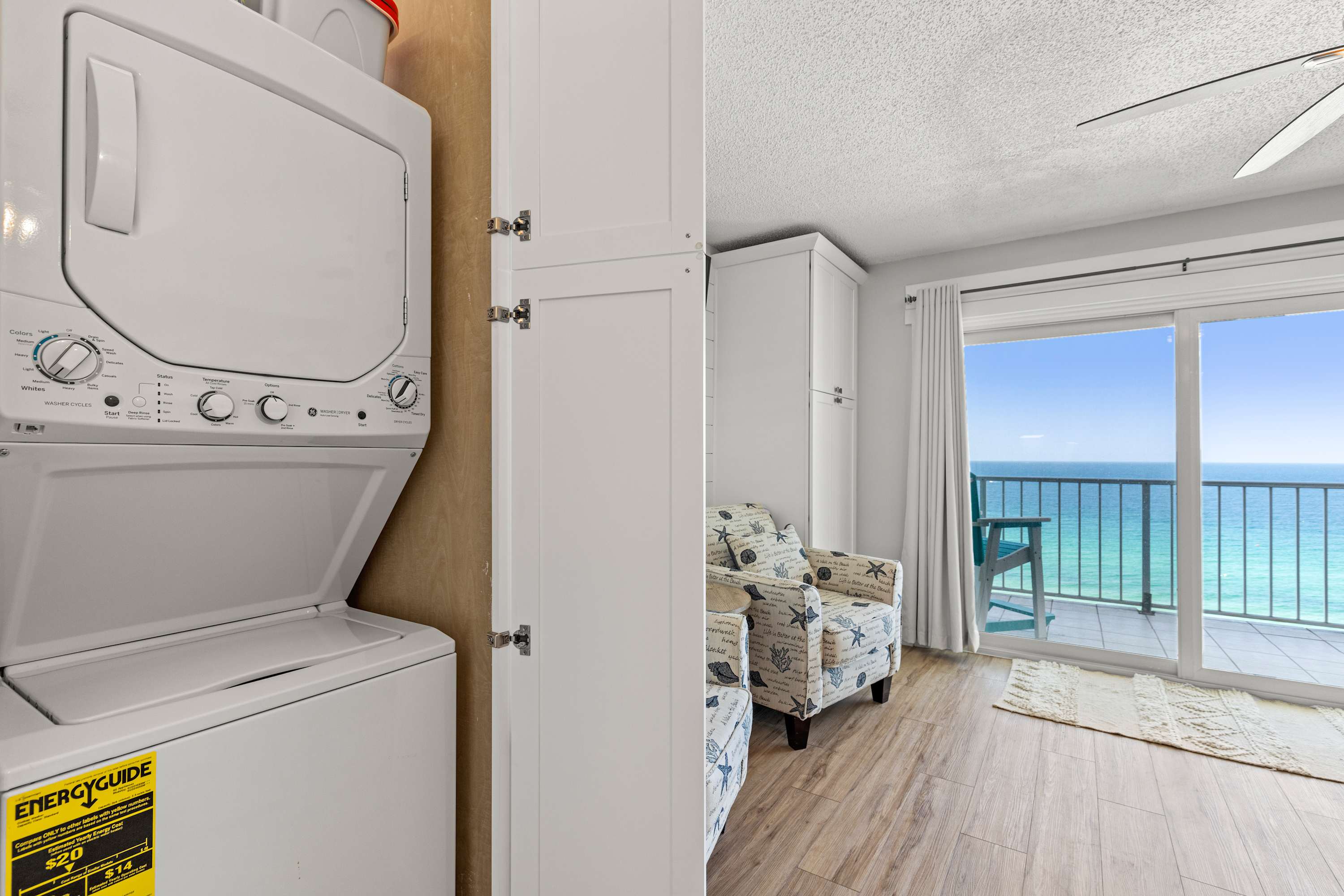 The Summit 1419 – Washer and dryer, seating area with ocean view, and sliding glass door to balcony.