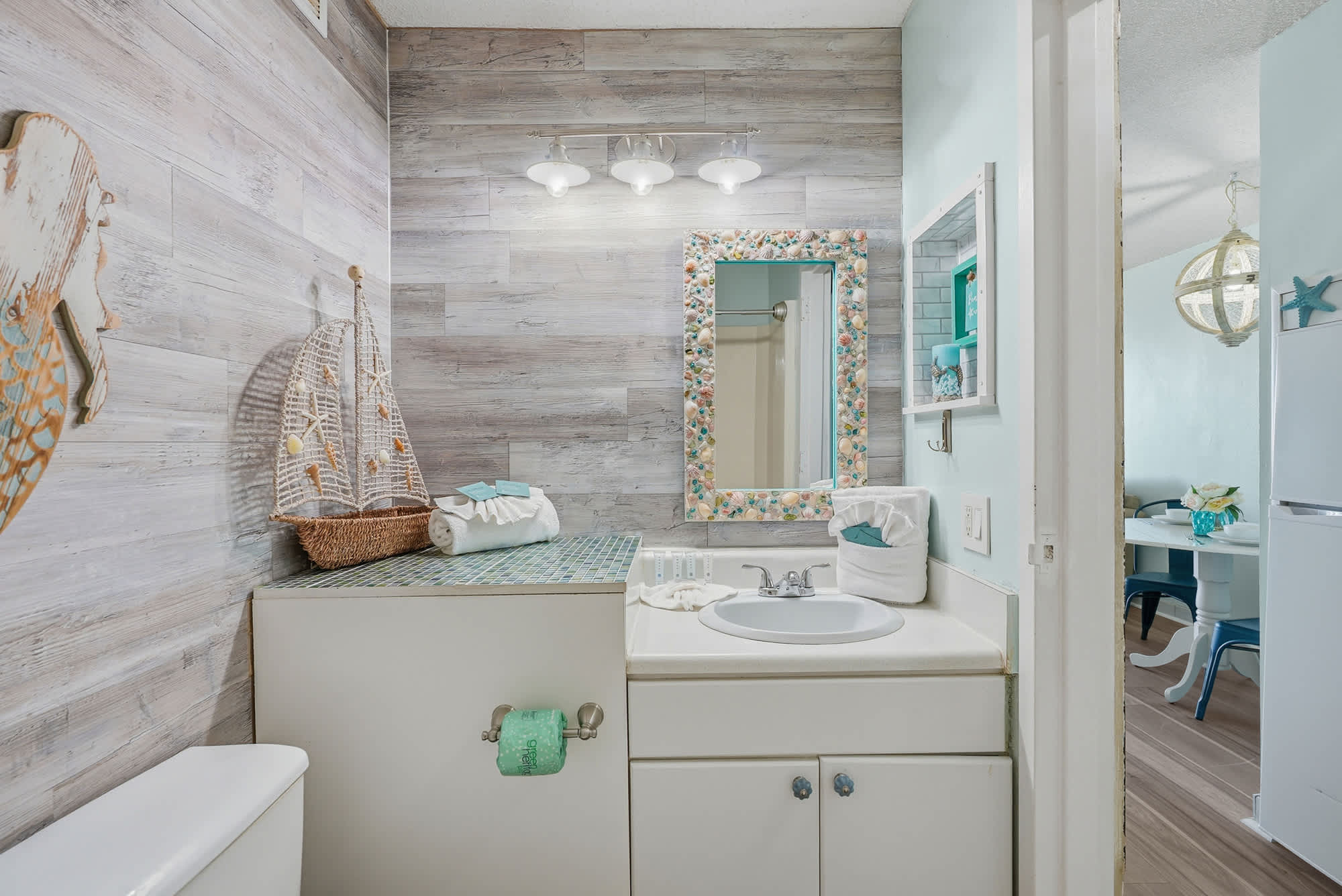 Top Of The Gulf  602 – Bathroom with a vessel sink, decorative mirror, and nautical-themed decor.