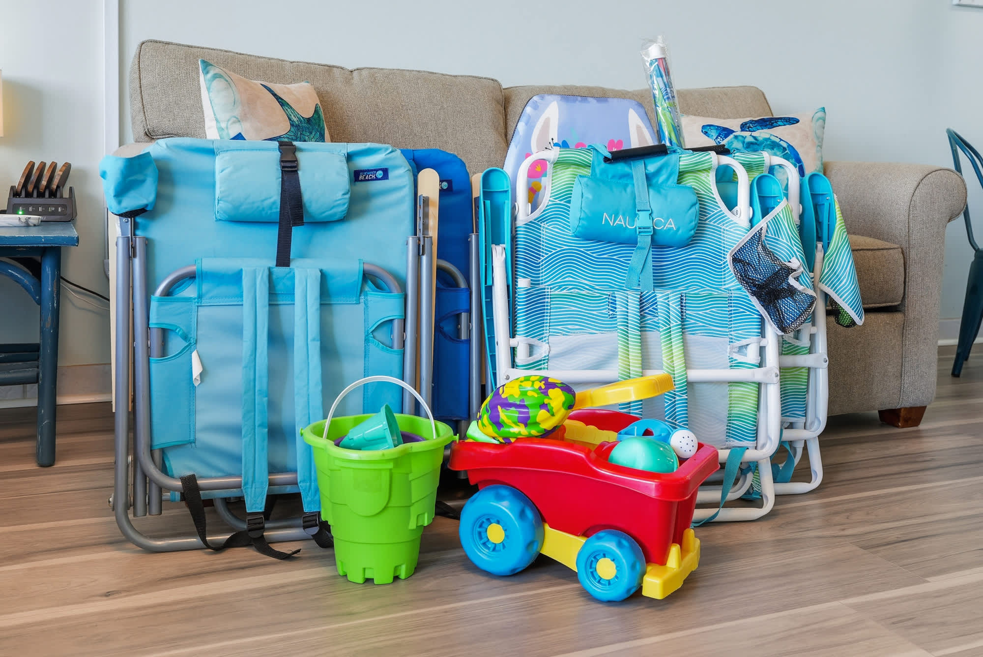 Top Of The Gulf  602 – Living area with a couch, beach chairs, and children's toys, including a bucket and truck.