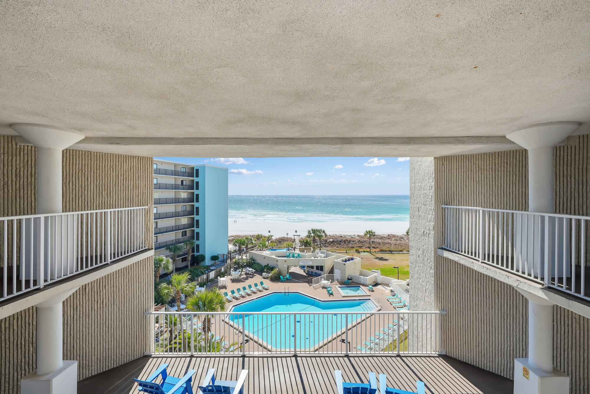 Top Of The Gulf  602 – View from balcony showing pool, beach, and ocean in the background.