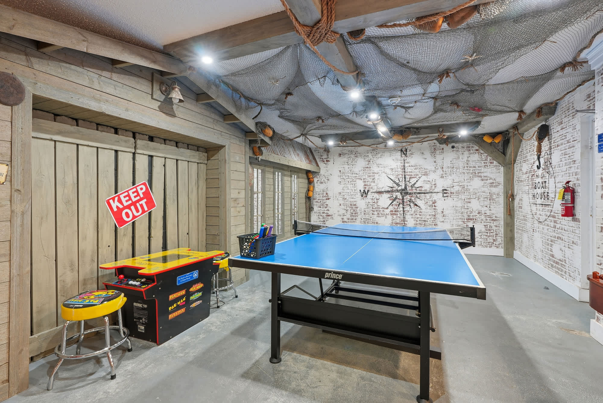 Top Of The Gulf  602 – Game room with ping pong table, arcade machine, and nautical-themed decor.