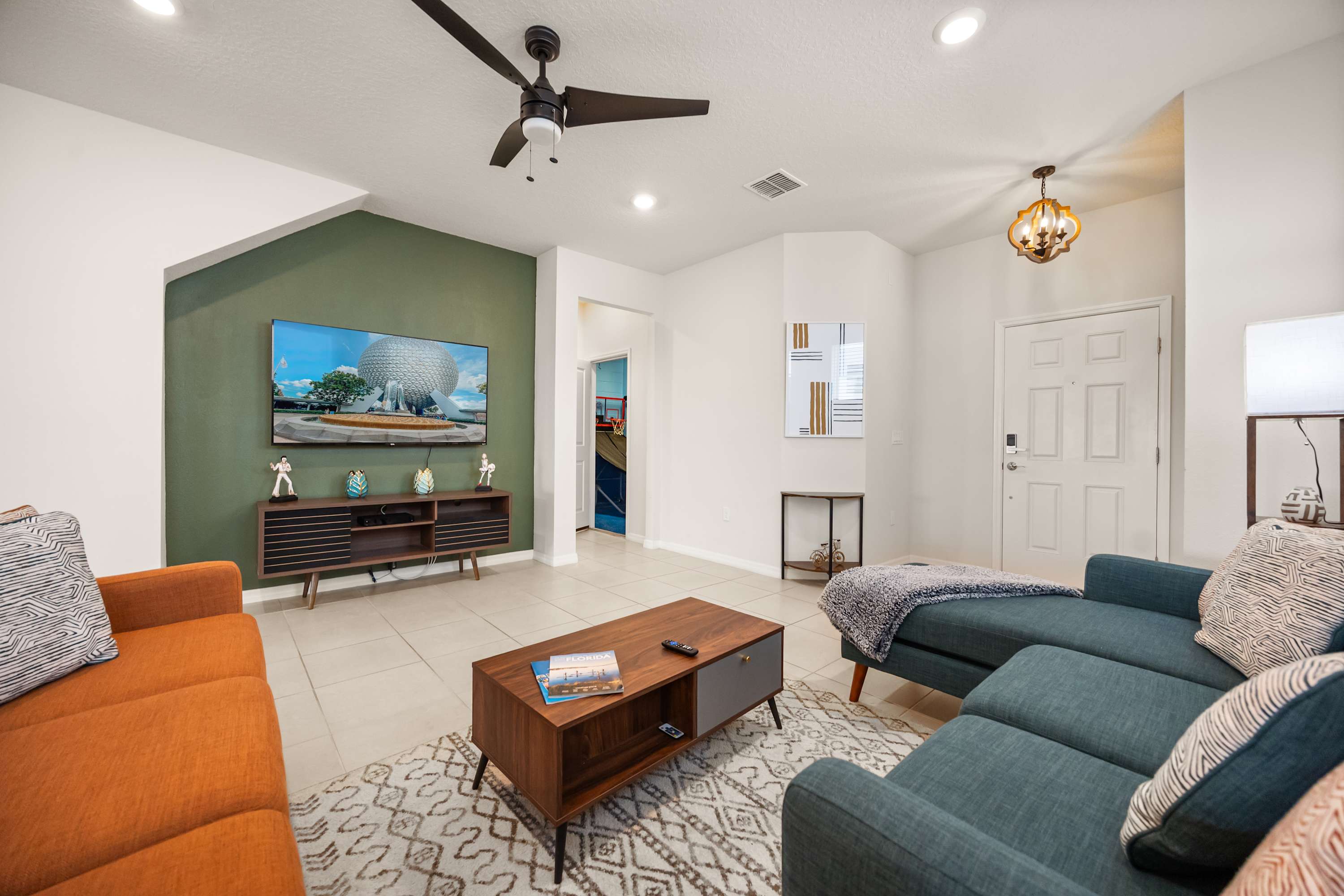Relax in this stylish living room with a large TV and comfy seating, perfect for unwinding after a day of exploring.