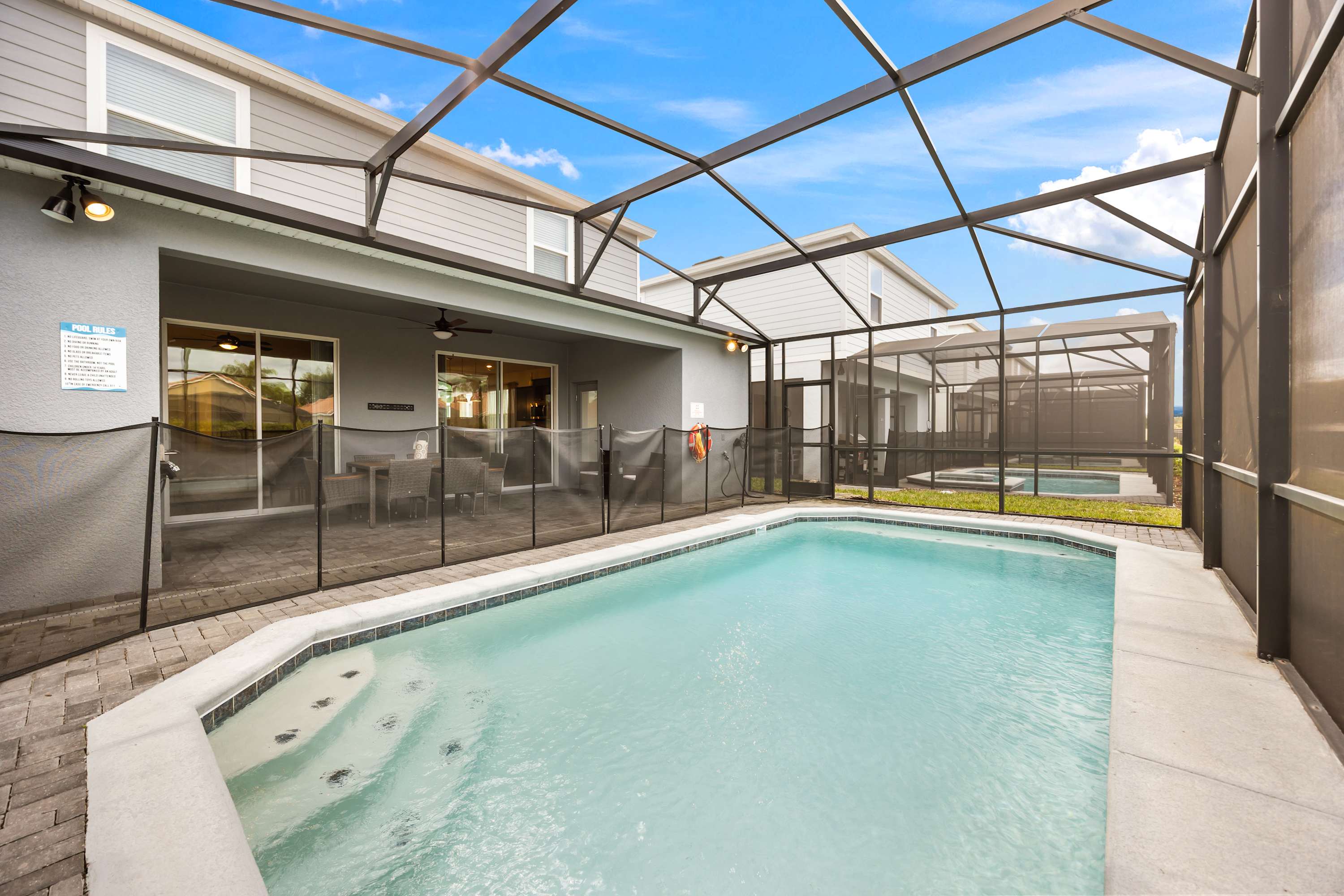 Relax by your private screened pool and enjoy outdoor dining in this spacious villa retreat.