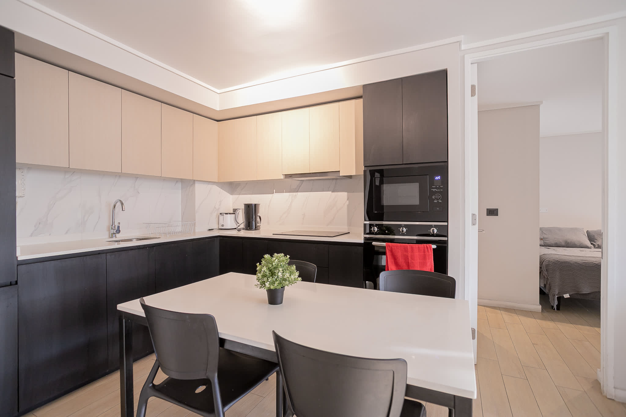 Sleek, modern kitchen with dining area, perfect for cozy meals and gatherings.
