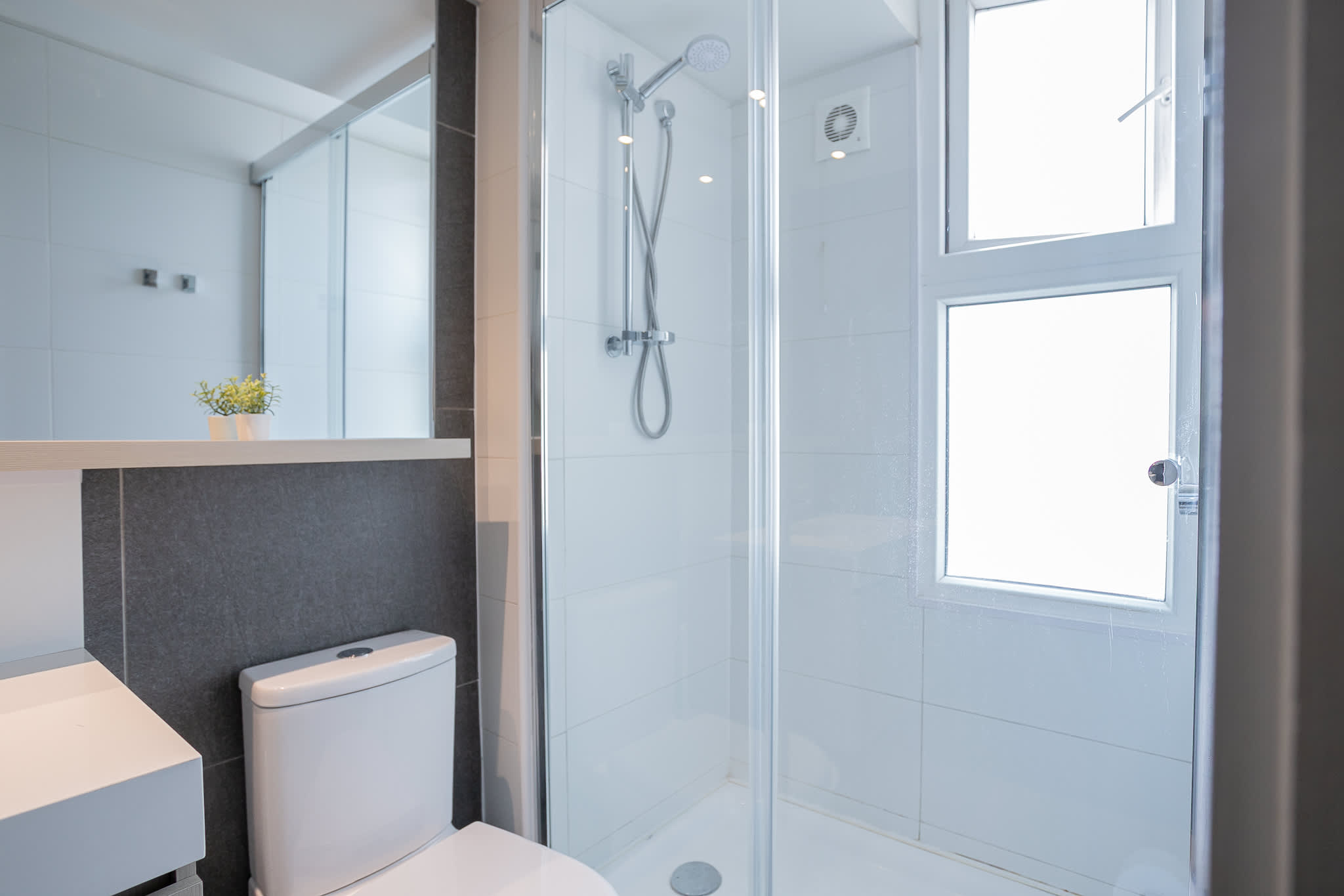Modern bathroom with natural light and sleek design, perfect for a refreshing start to your day.