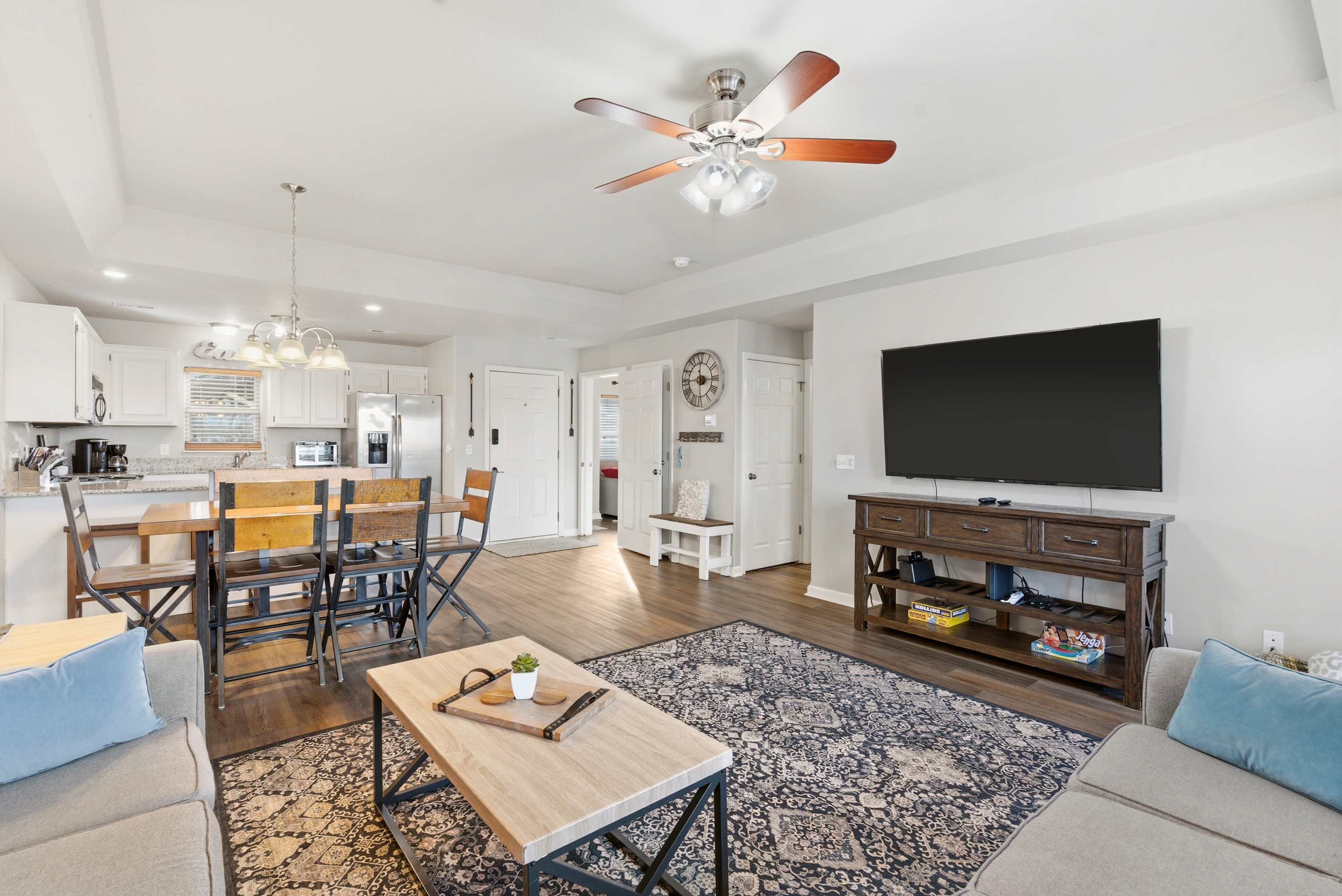 Open living space with Queen sofa sleeper, TV, and deck access