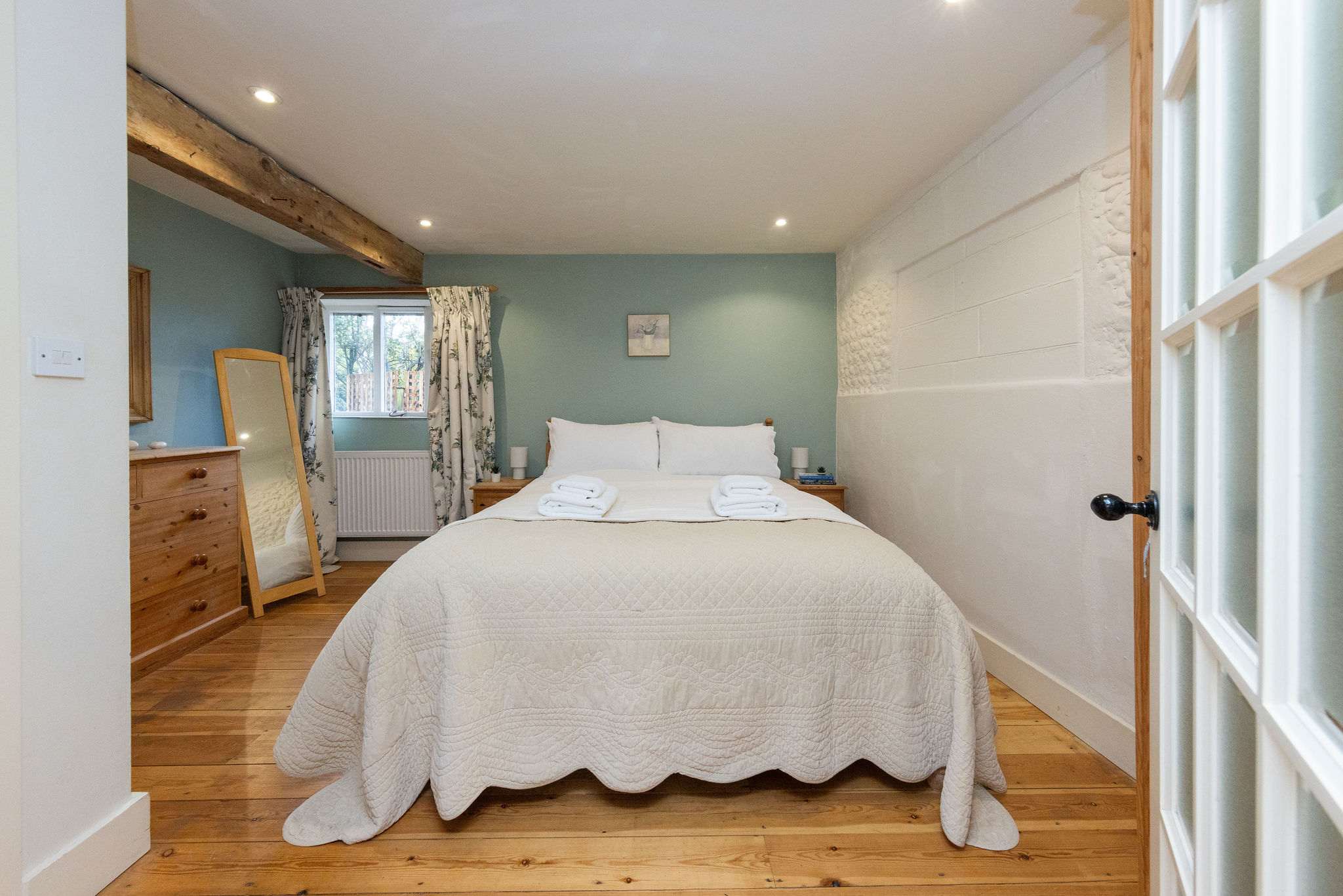 The master bedroom has a comfy superking, with cushions and throws for a cosy night sleep.