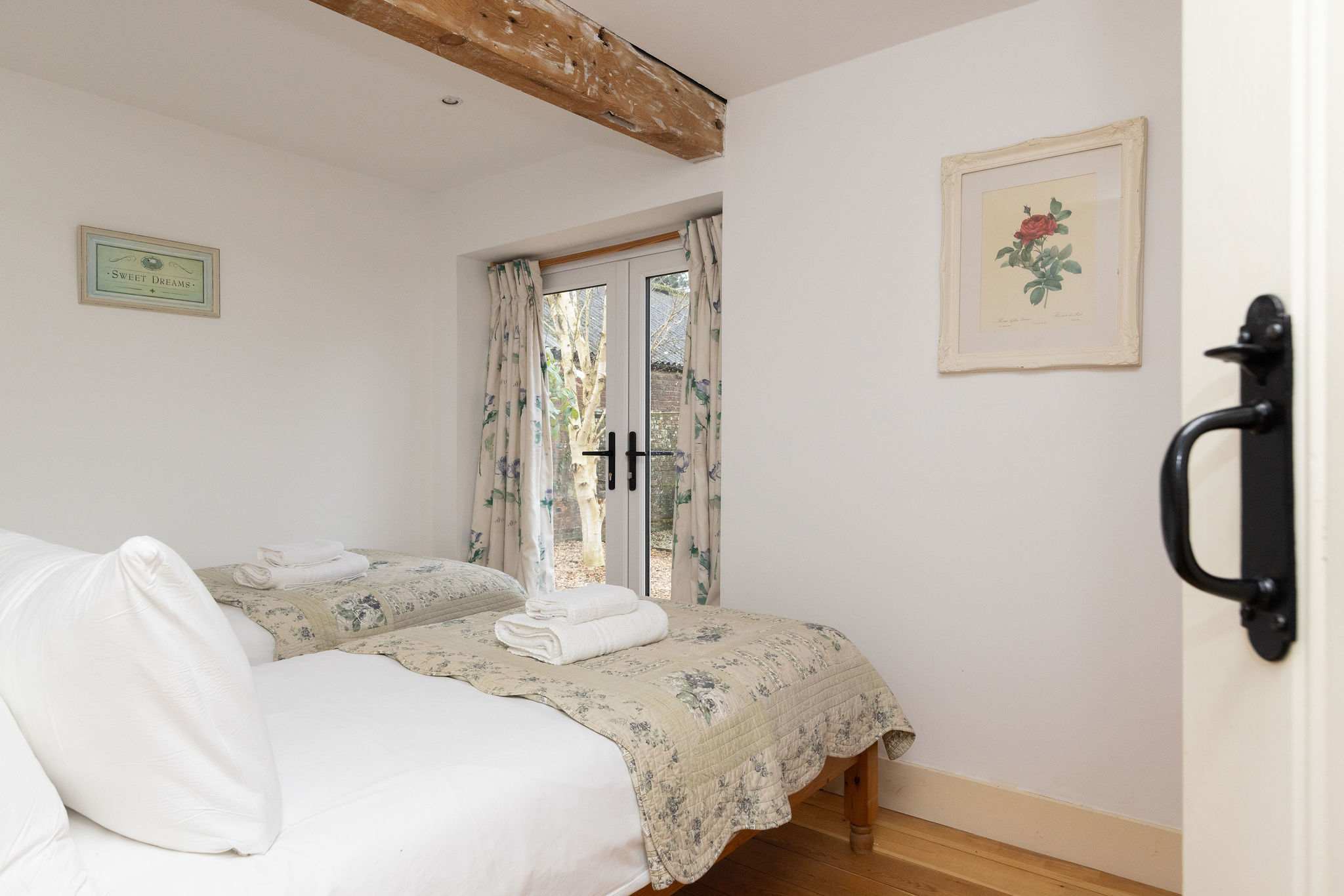 The downstairs twin with quality linen and pretty bed throws.