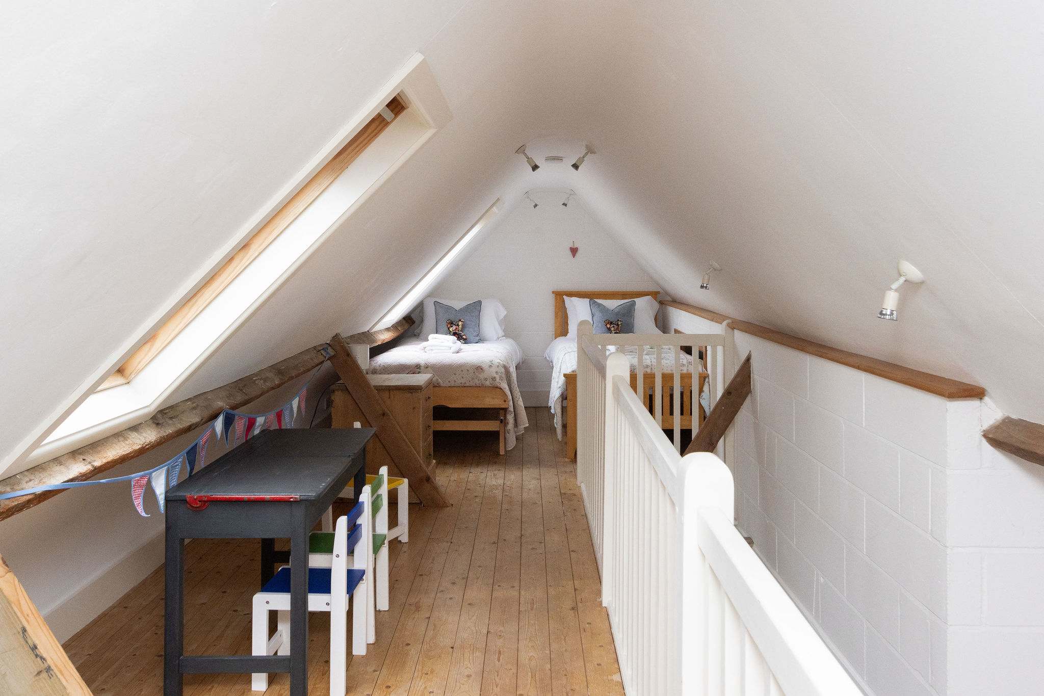 The mezzanine bedroom is open to the space below and accessed via stairs.