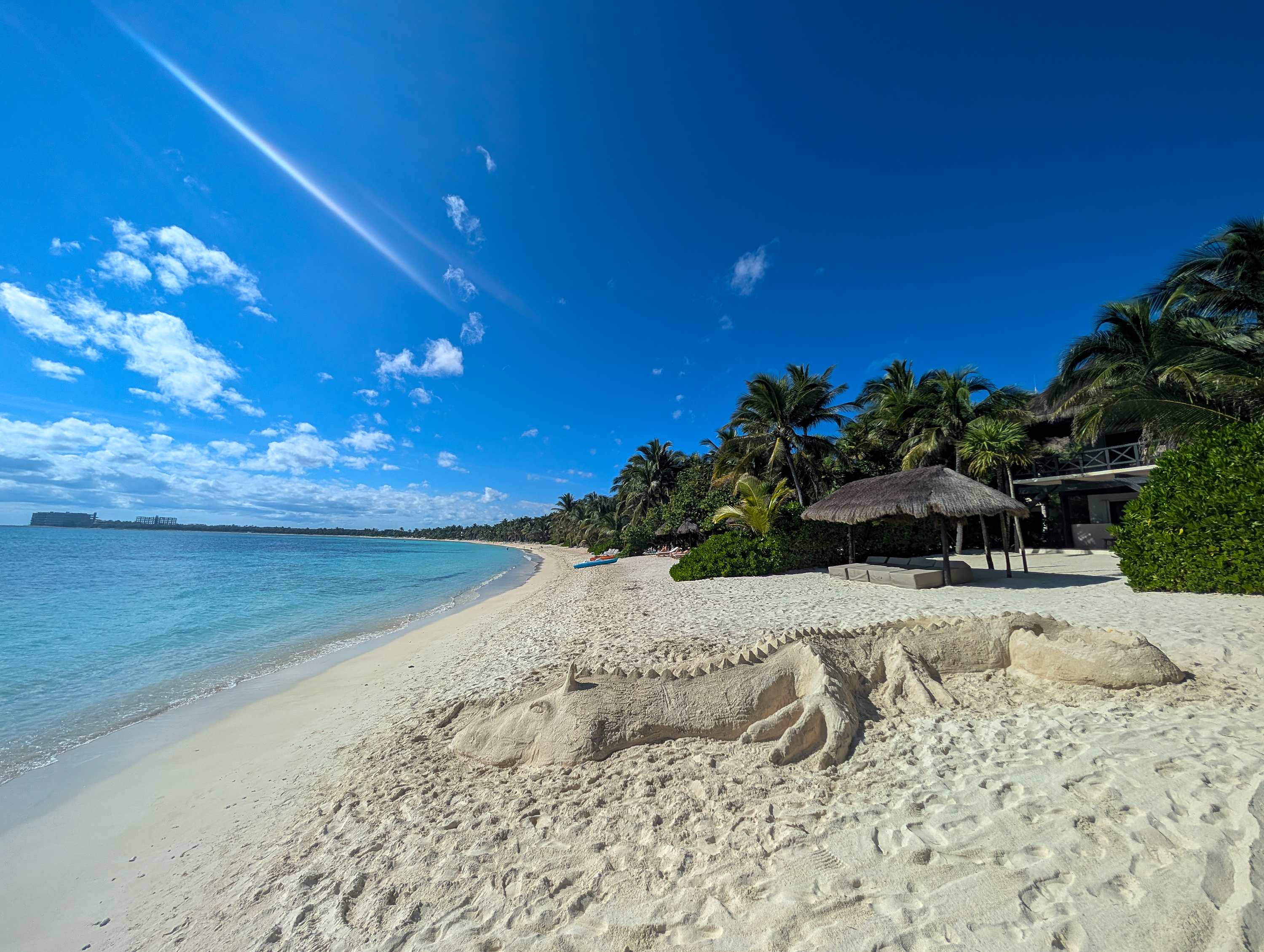 A serene view of soft sand and turquoise sea 