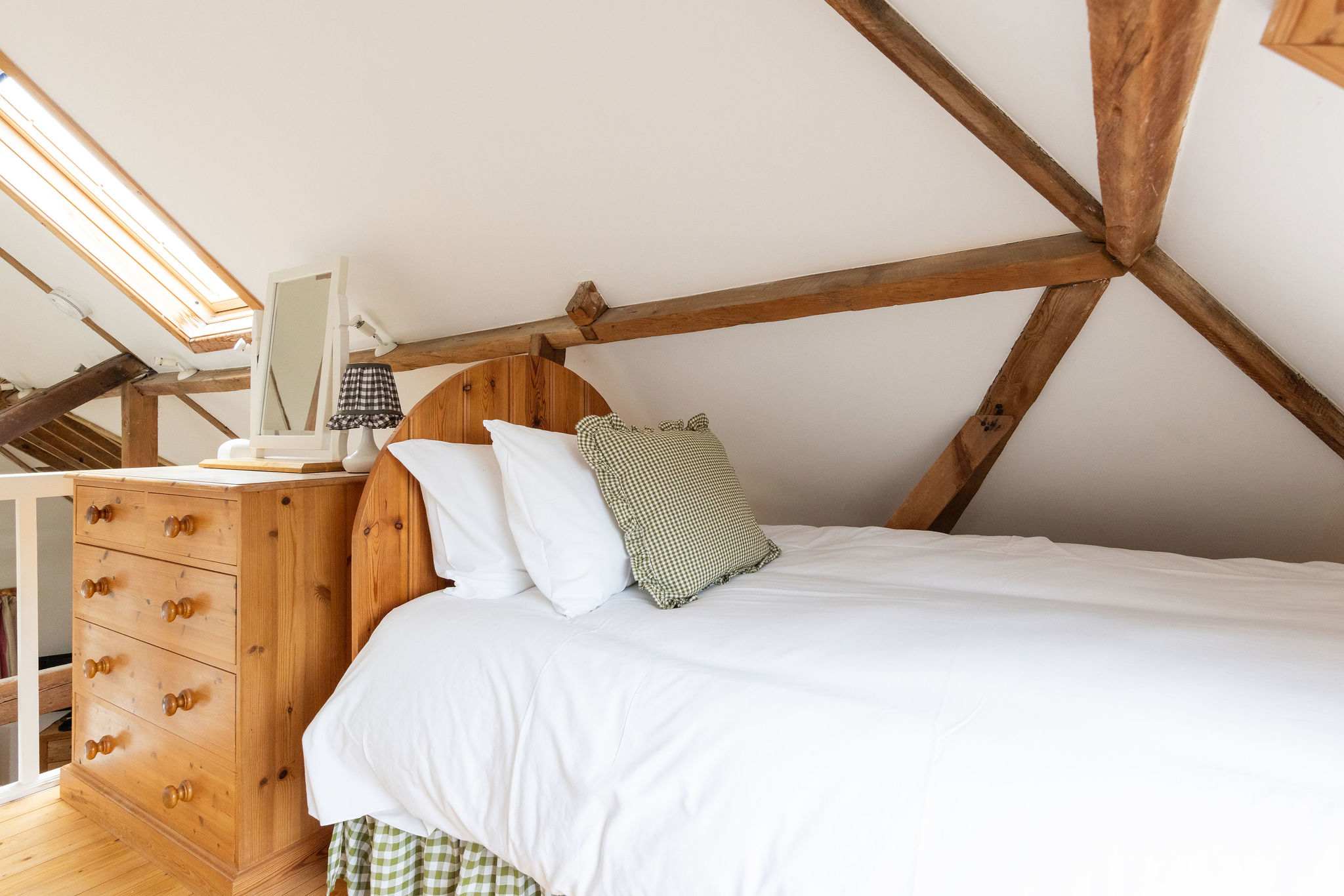 Drift off beneath original timber beams in the cosy mezzanine twin bedroom.
