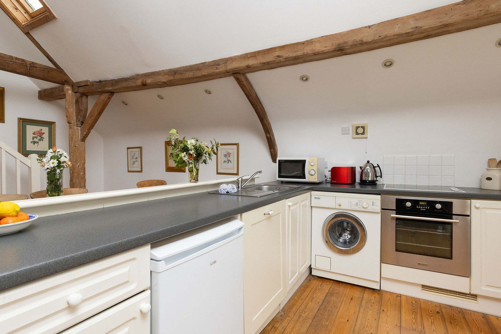 The kitchen features plenty of prep space and all the essentials, including a oven, microwave, kettle and toaster, making meal times a breeze.
