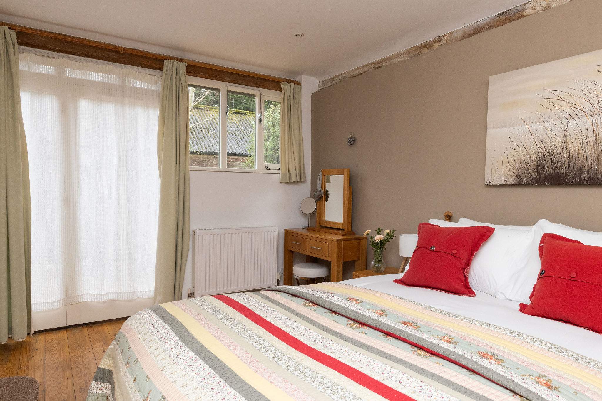 King bedroom with fresh linens, countryside views, and ensuite bathroom.