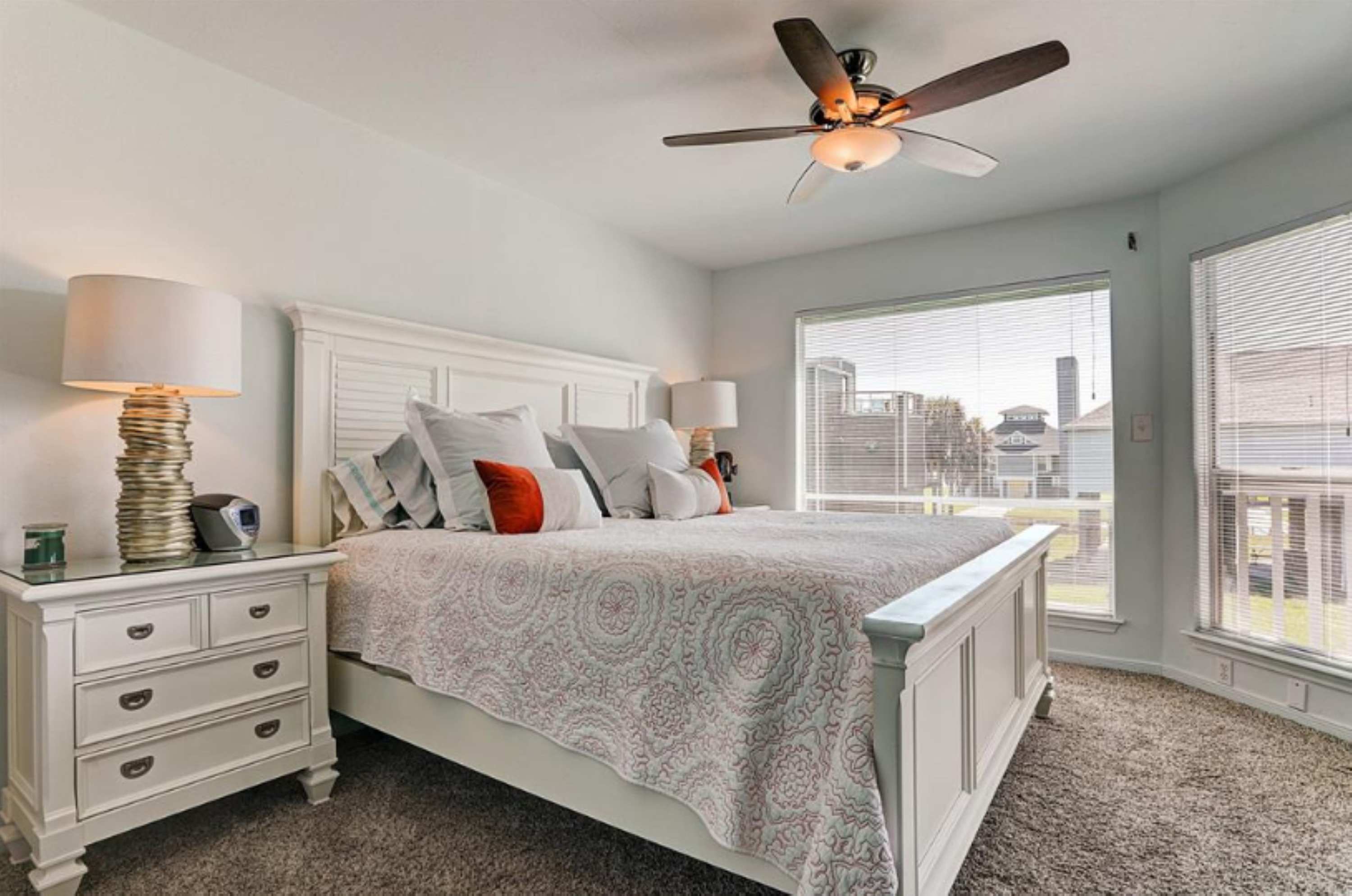 Bedroom 2 with king bed, deck access, and ensuite 