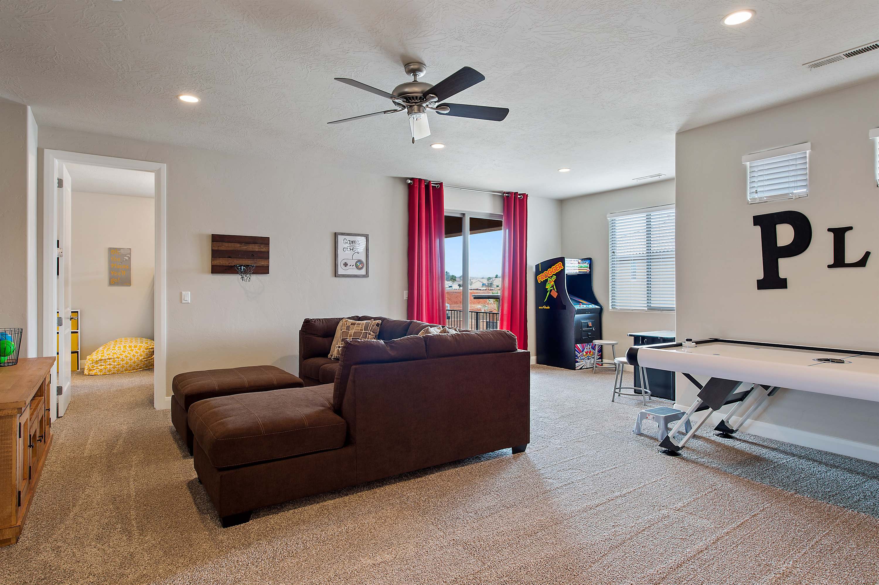 Spacious upstairs family room with games and seating
