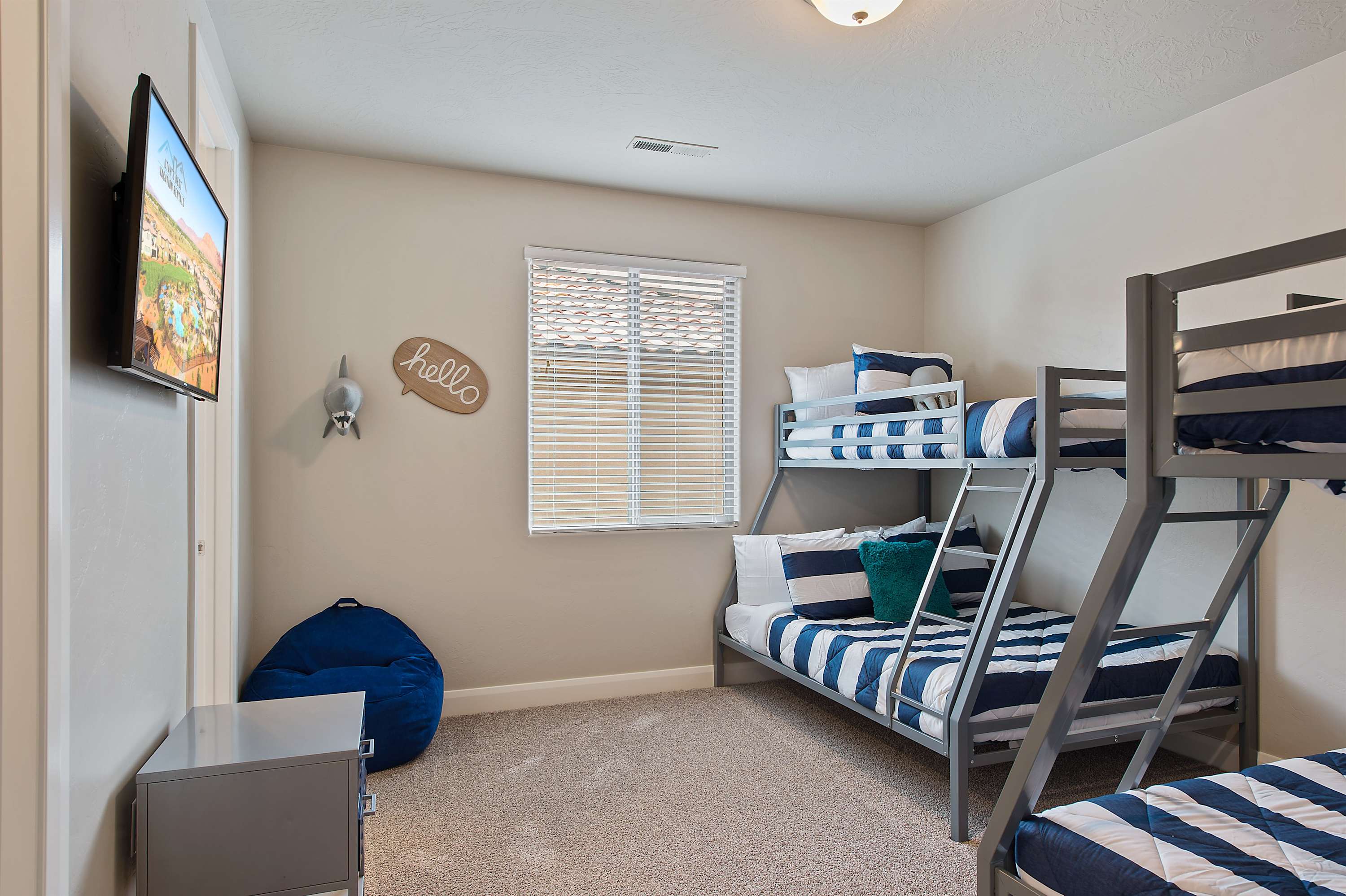 Sleep up to 6 in this ocean-themed bunk room with TV
