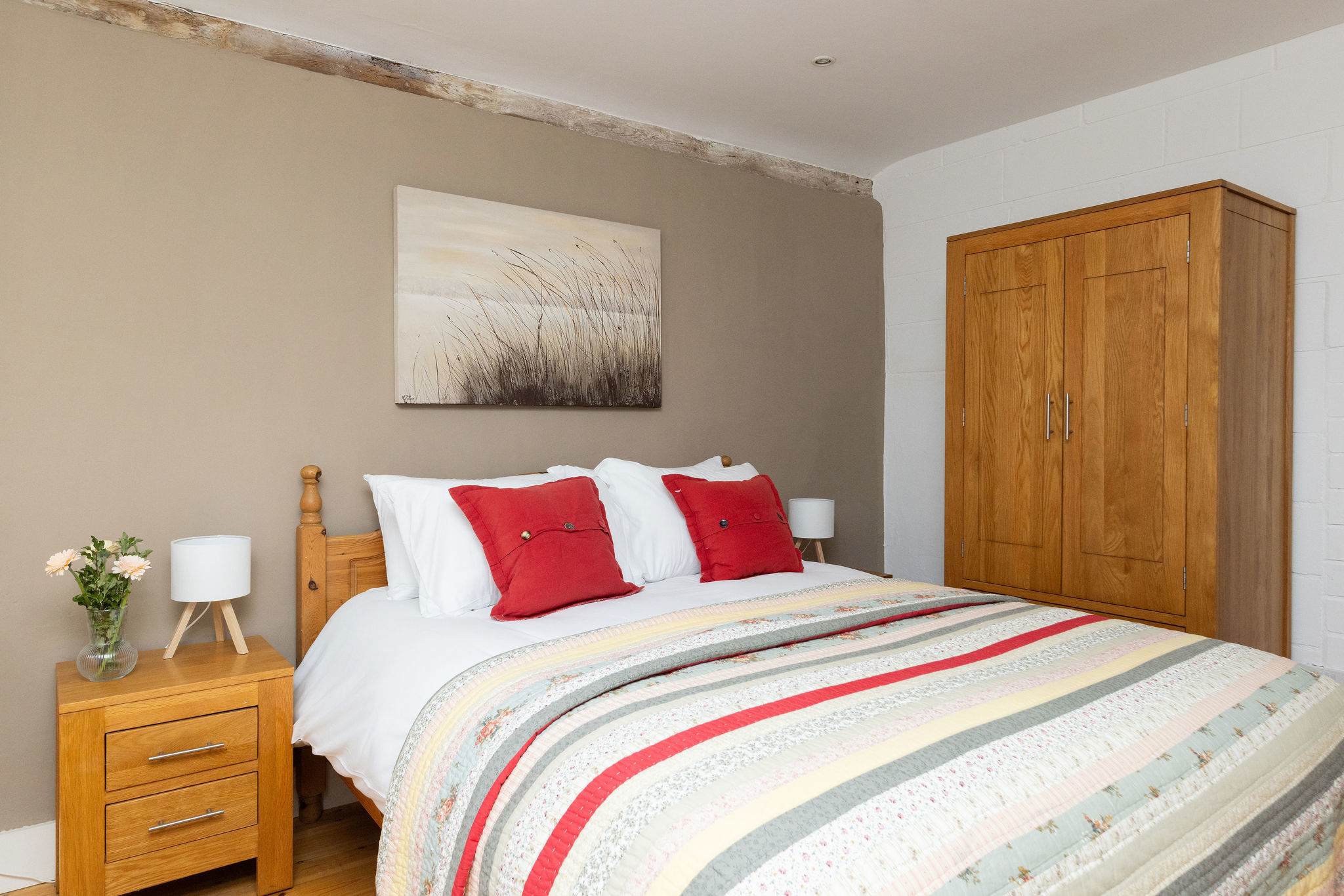 Rest easy in Wren Barn's serene master bedroom, where rustic charm meets modern comforts.