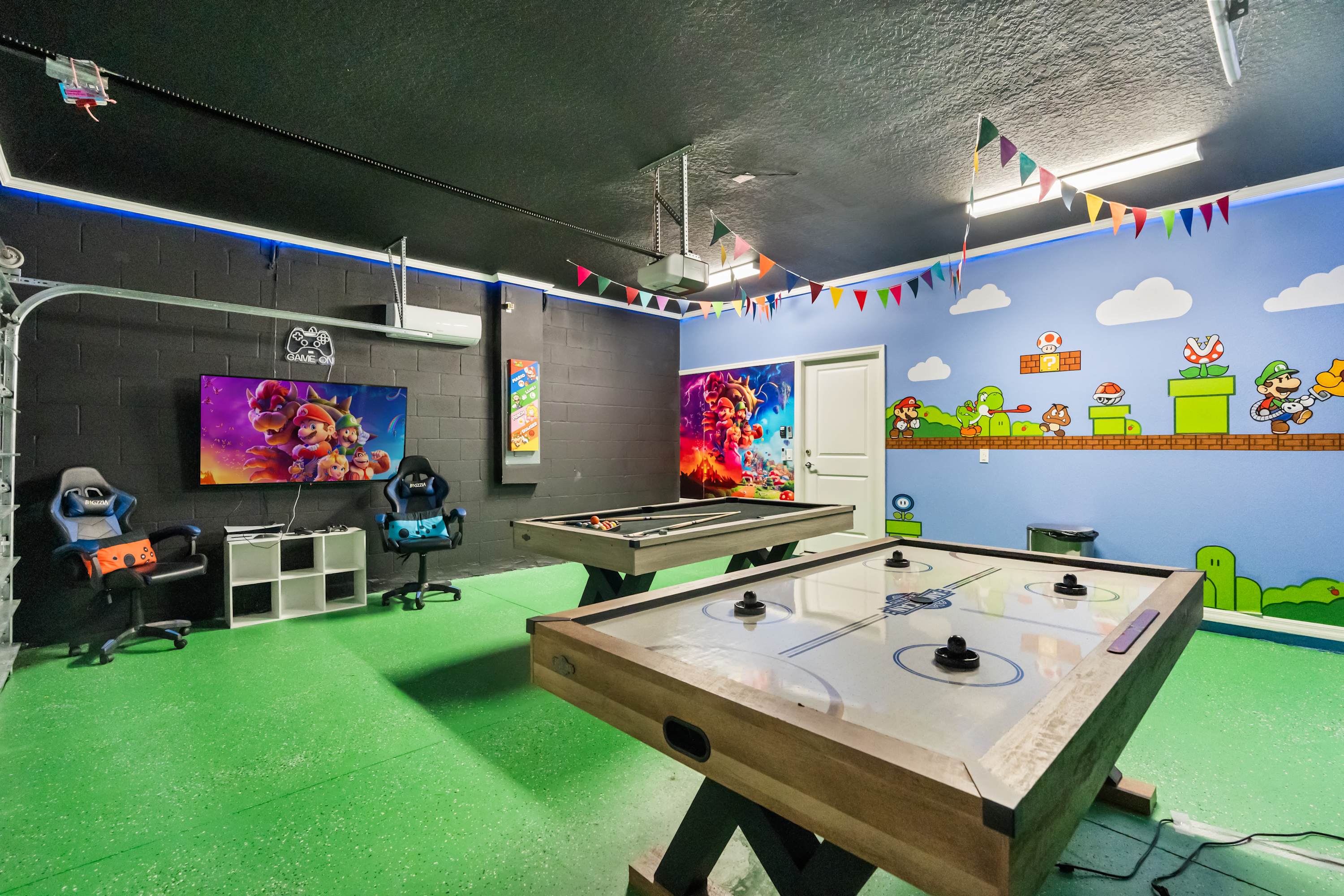 Dive into fun in this vibrant game room with air hockey, pool, and gaming setup. Perfect for family entertainment!