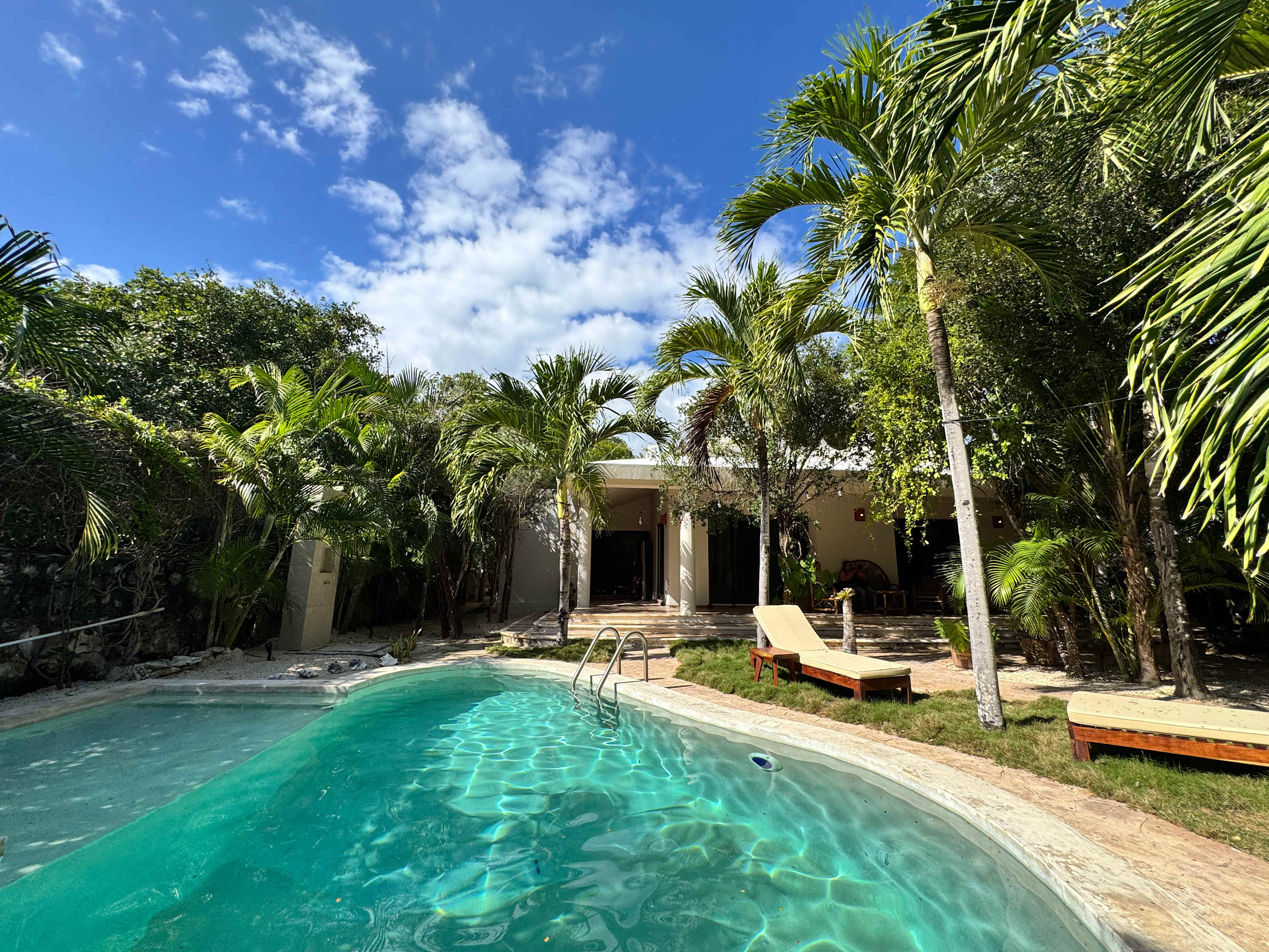 Pool view, surrounded by lush gardens.