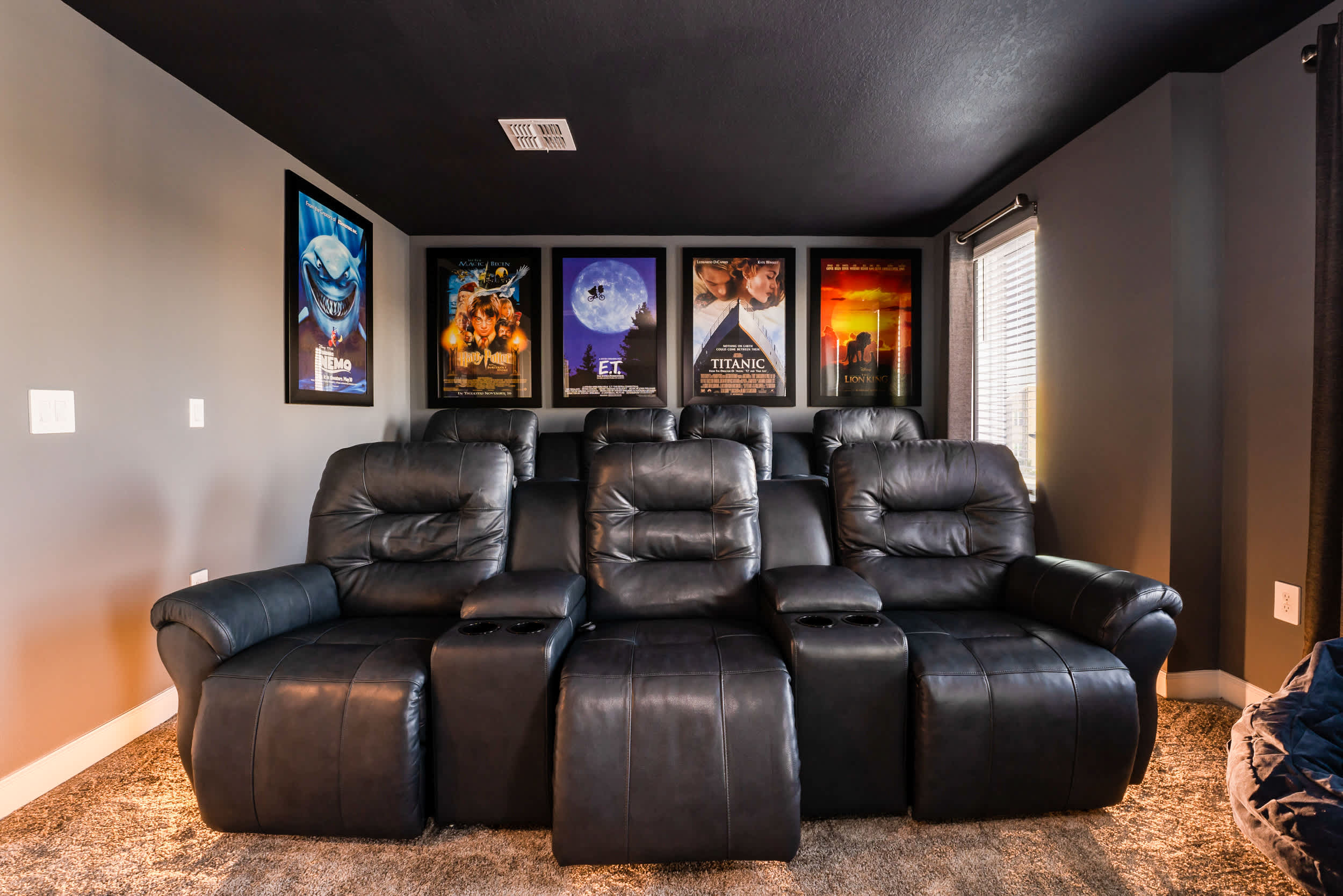 Enjoy movie nights in your private home theater with plush recliners and iconic film posters.