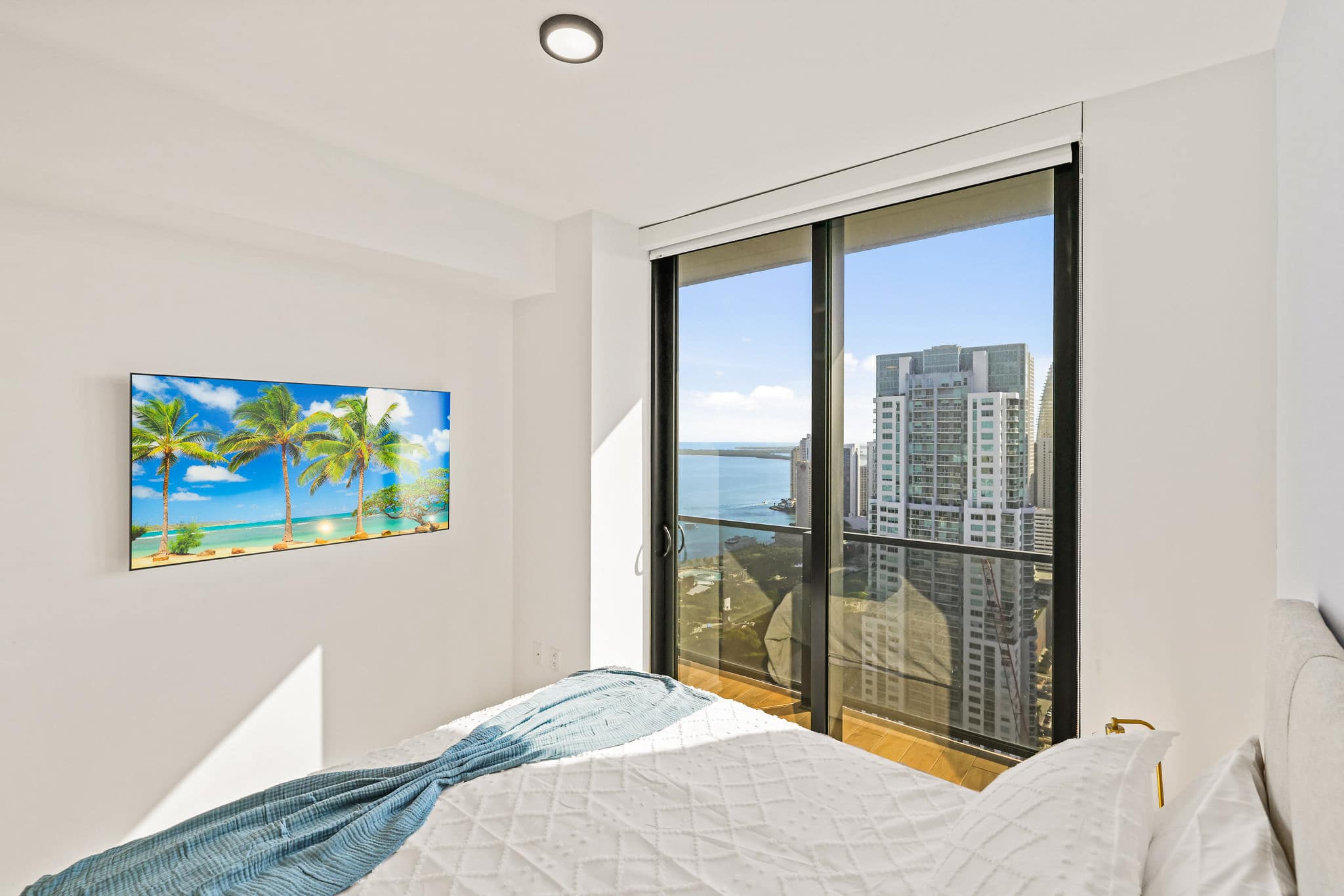 Wake up to breathtaking city and water views from this cozy bedroom retreat.
